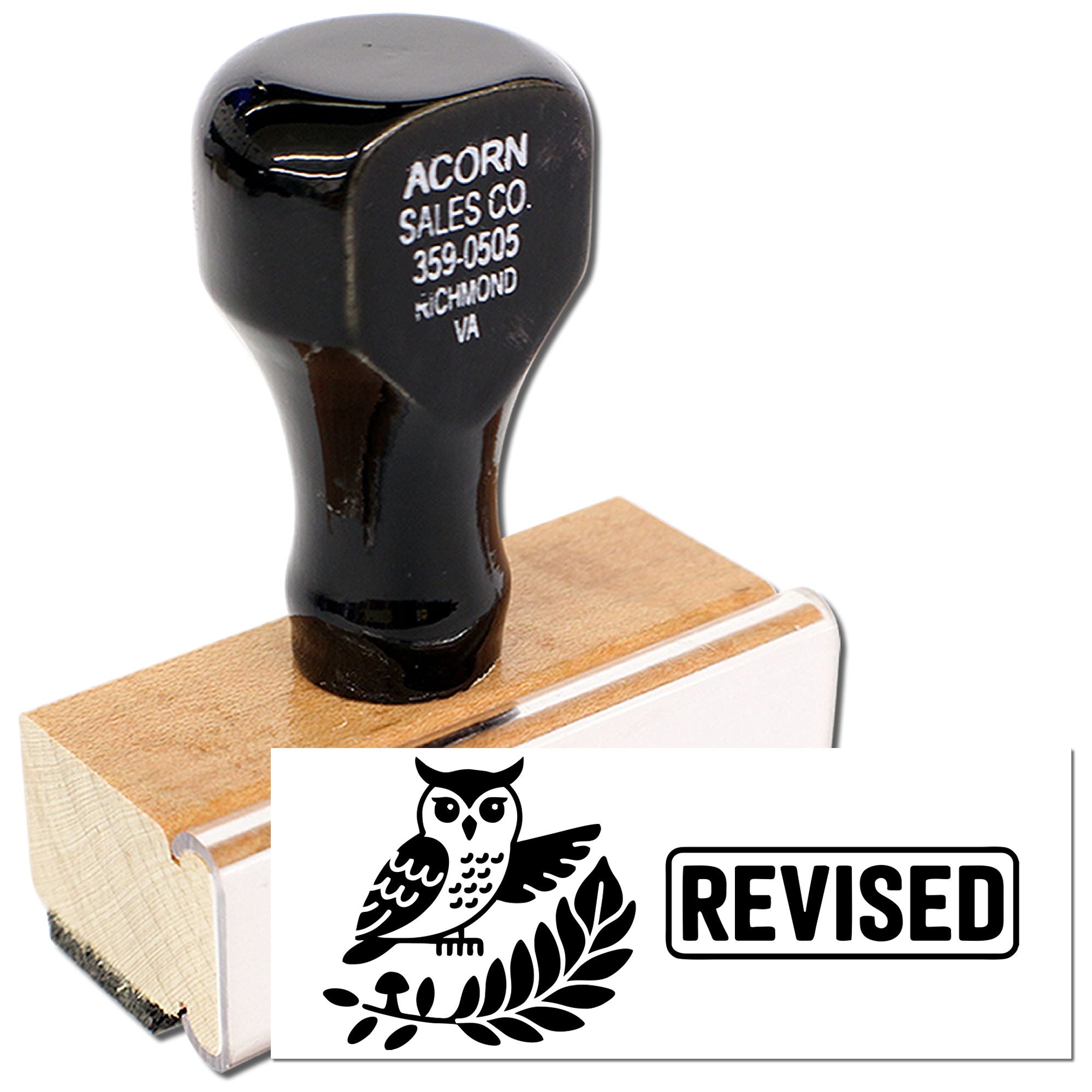 Custom rubber stamp with owl design and REVISED imprint for office document review.