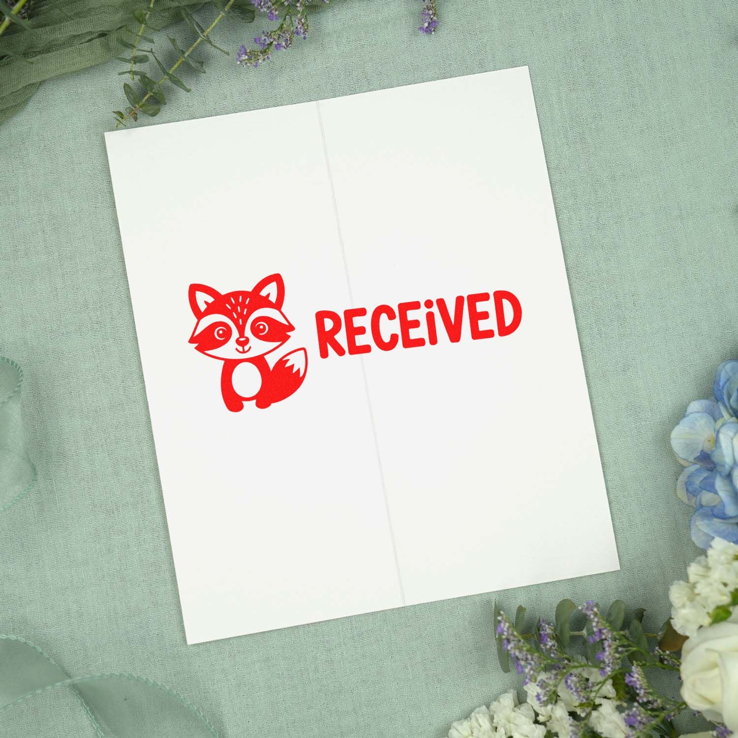 Red fox RECEIVED rubber stamp on folded paper for mail, packaging, and order processing