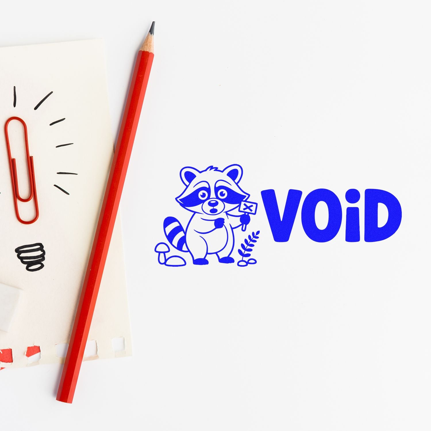 Blue VOID rubber stamp design with raccoon mascot, shown with pencil and paper clips on a white background.