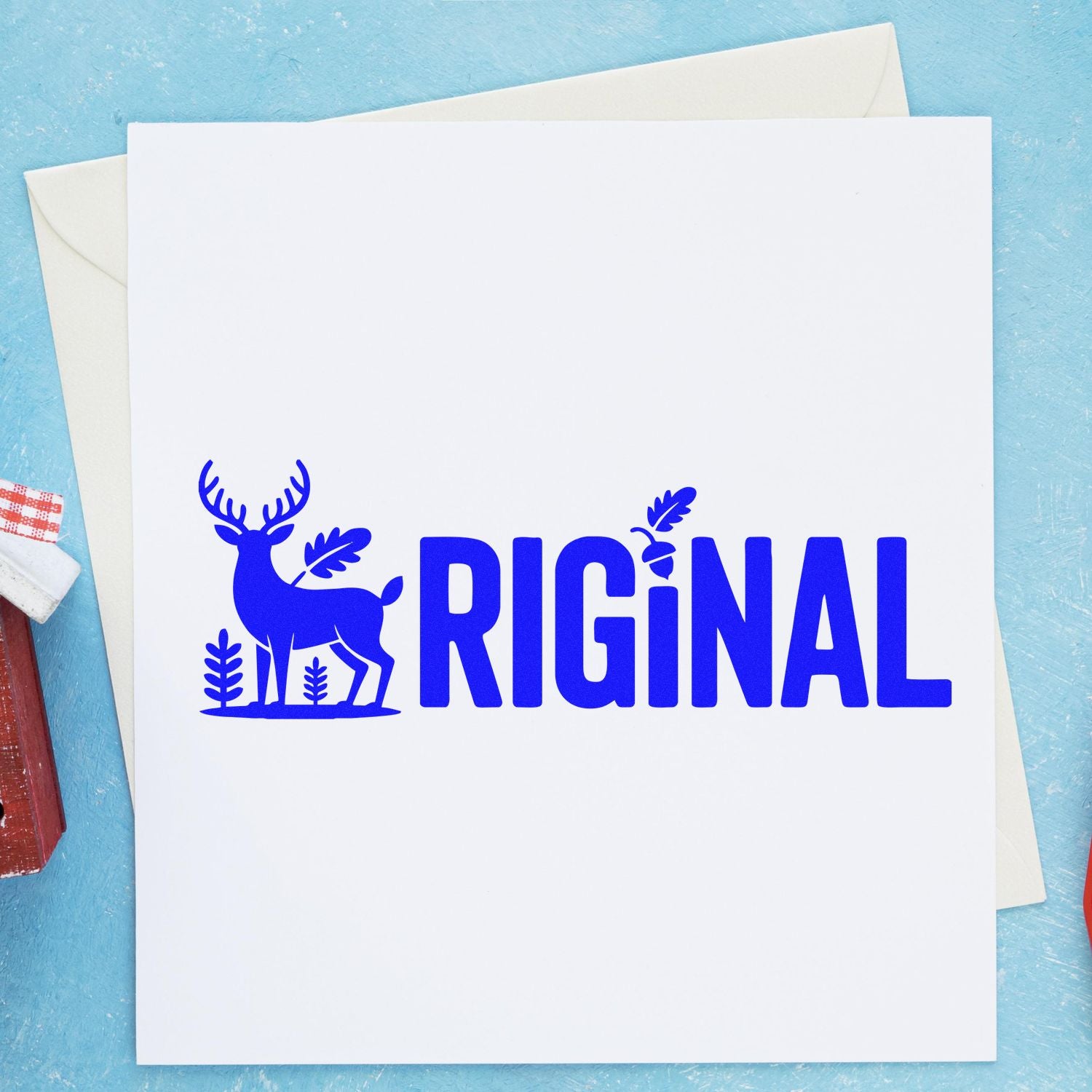 Custom rubber stamp impression with deer silhouette and bold blue RIGINAL text on white card.