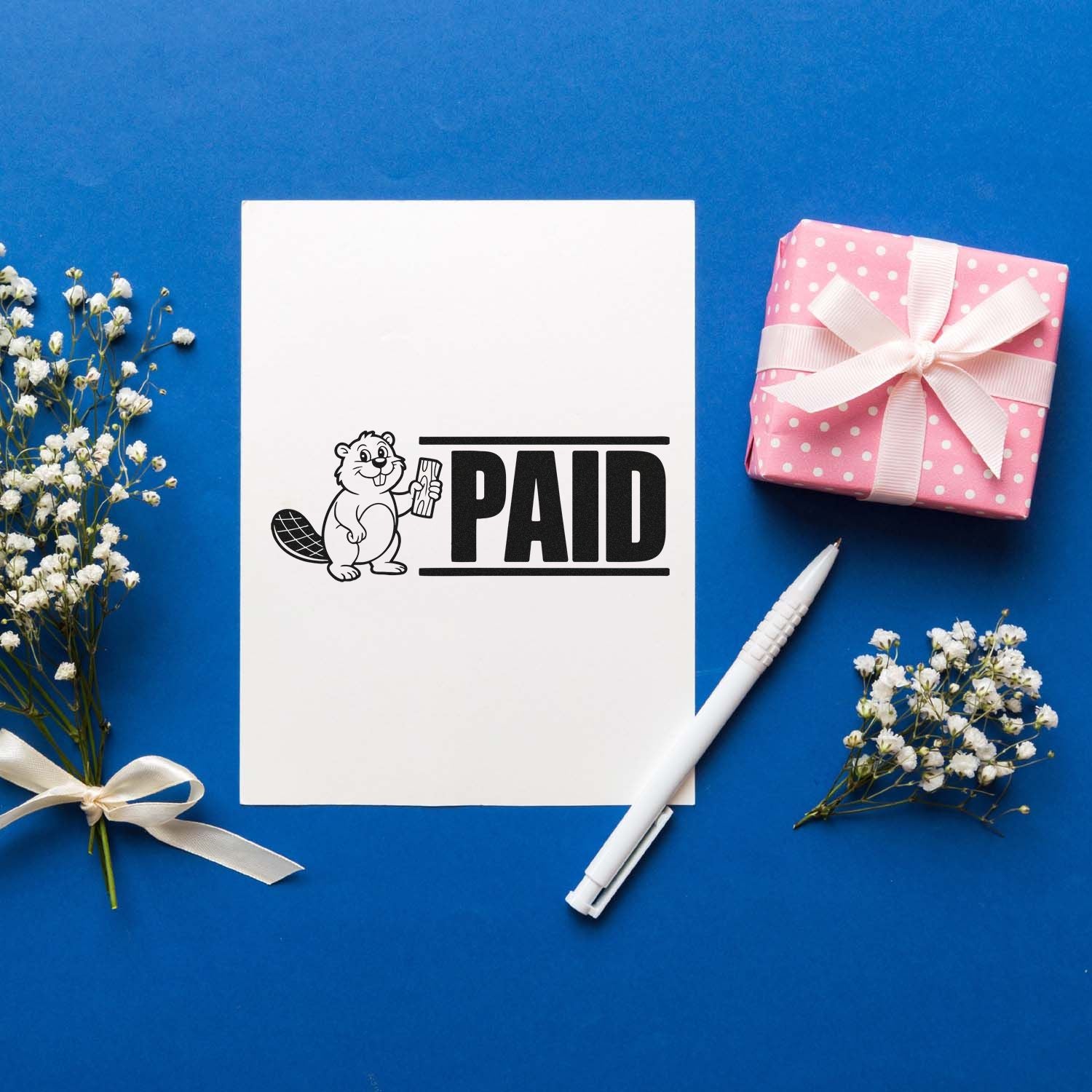 Custom PAID rubber stamp design with beaver illustration, ideal for invoice and office document marking.