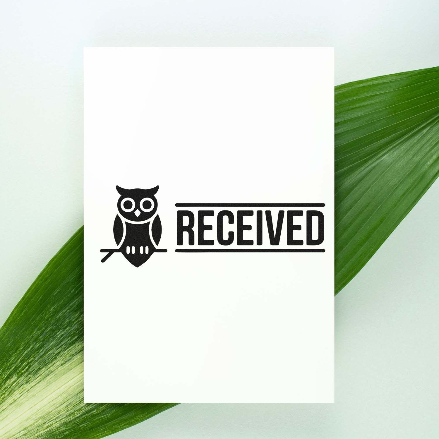 Owl RECEIVED rubber stamp impression on white card, ideal for office mail and document processing.