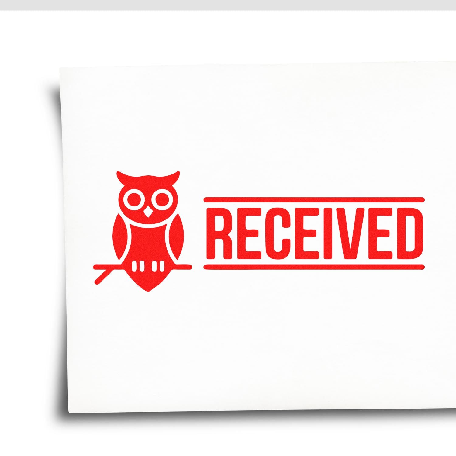 Red RECEIVED rubber stamp with owl icon on white paper for office document processing and approval.