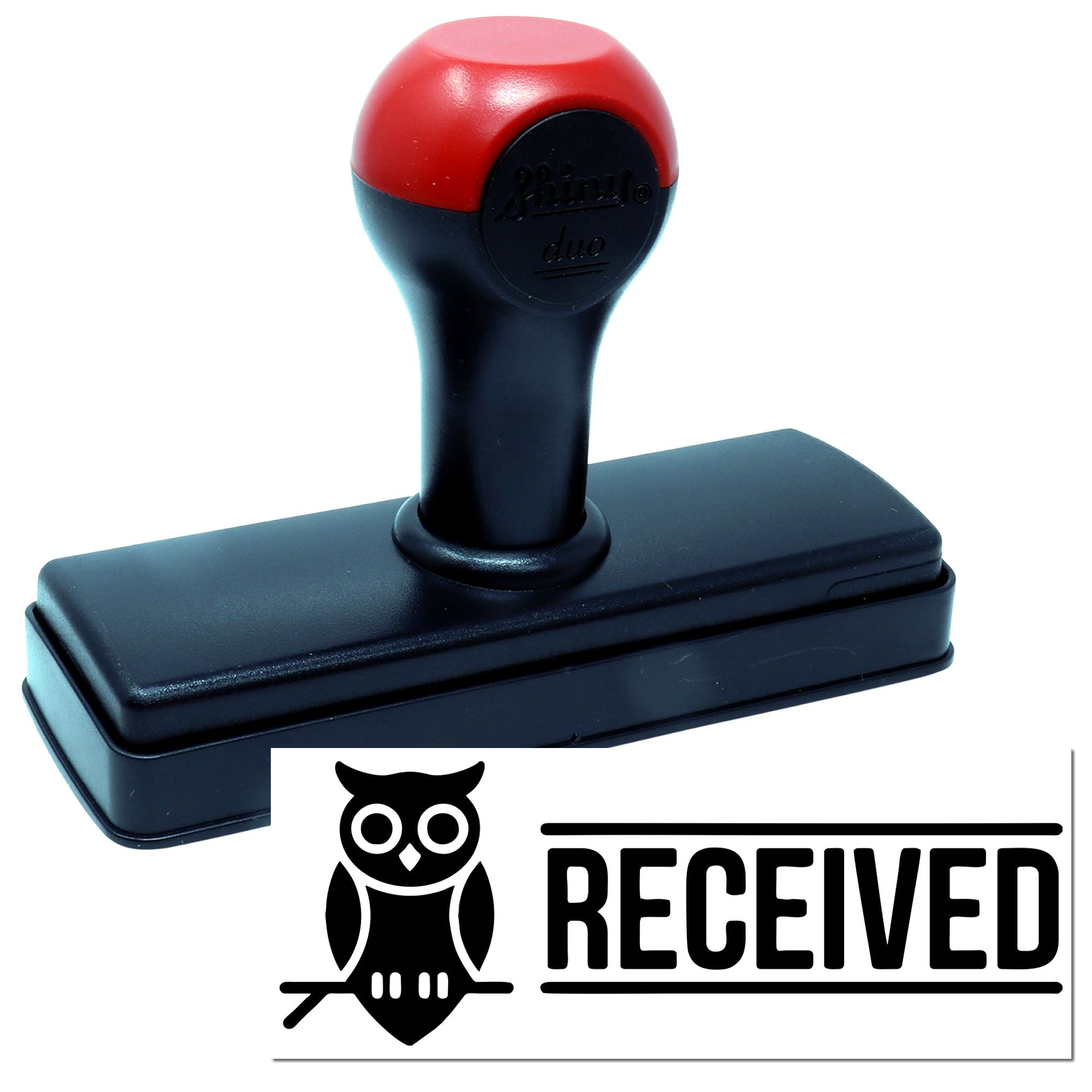 Self-inking rubber stamp with RECEIVED owl design for office document approval and filing.
