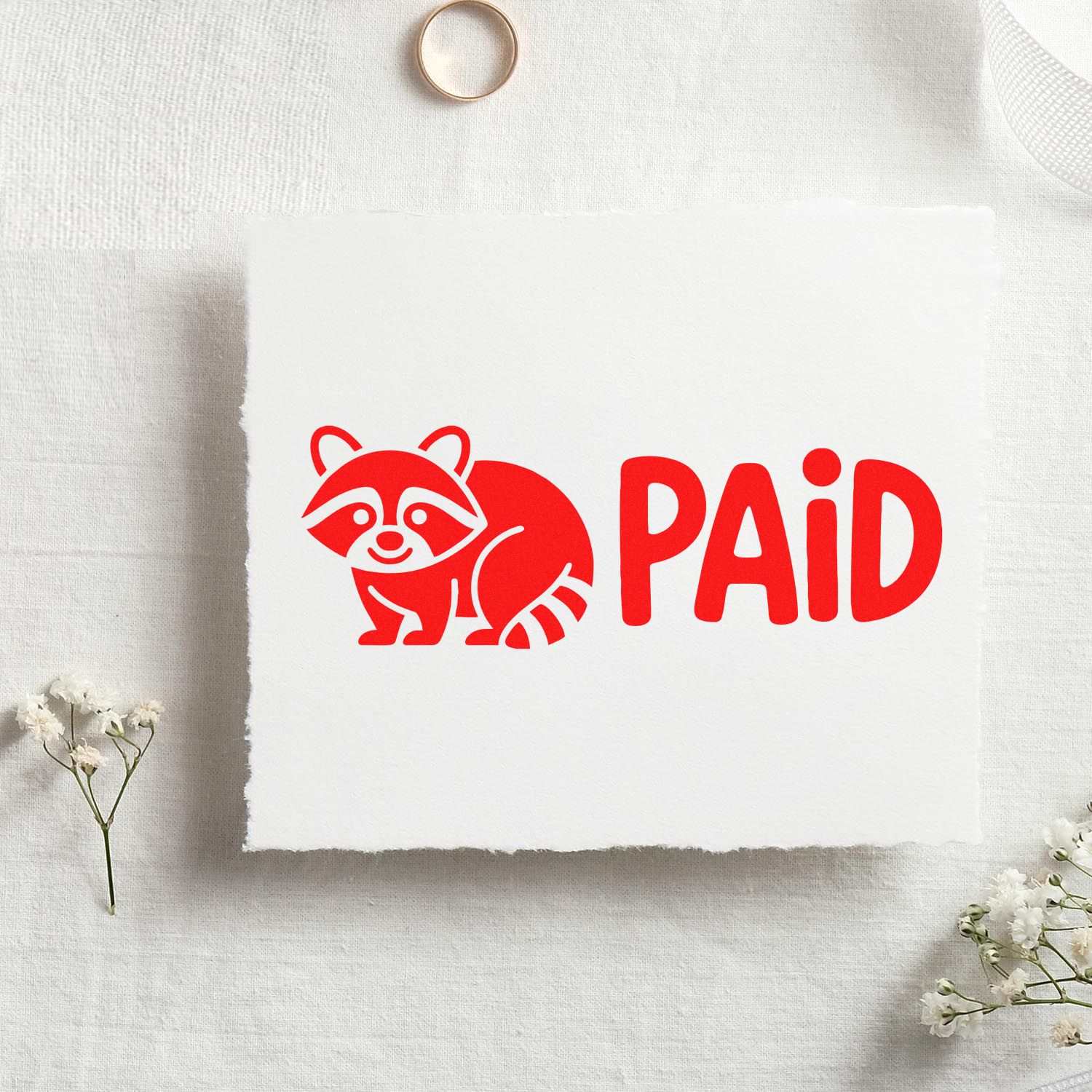 Red raccoon PAID rubber stamp for marking invoices, receipts, and payment-approved paperwork.