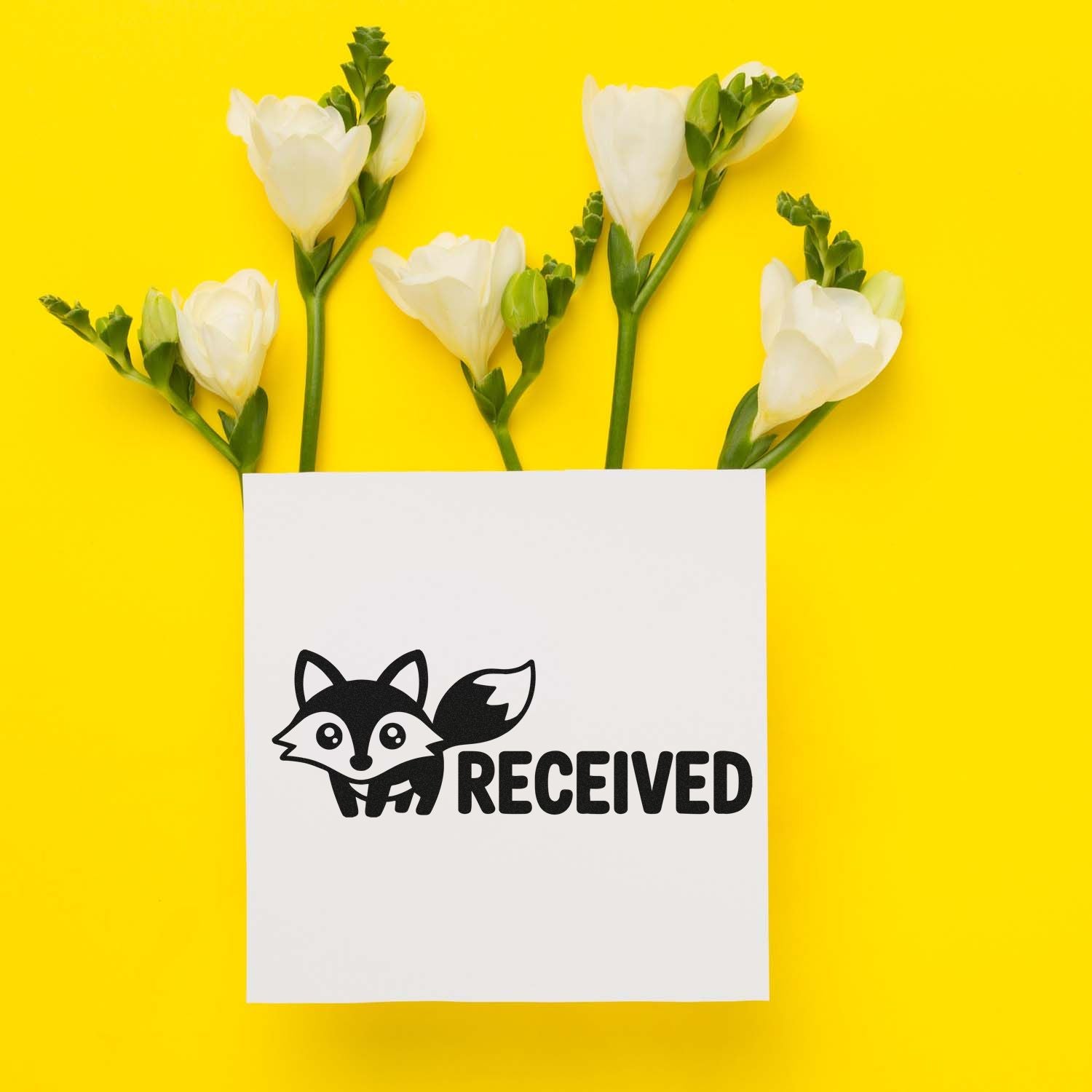 Received fox rubber stamp on white paper, styled with flowers on a bright yellow background.