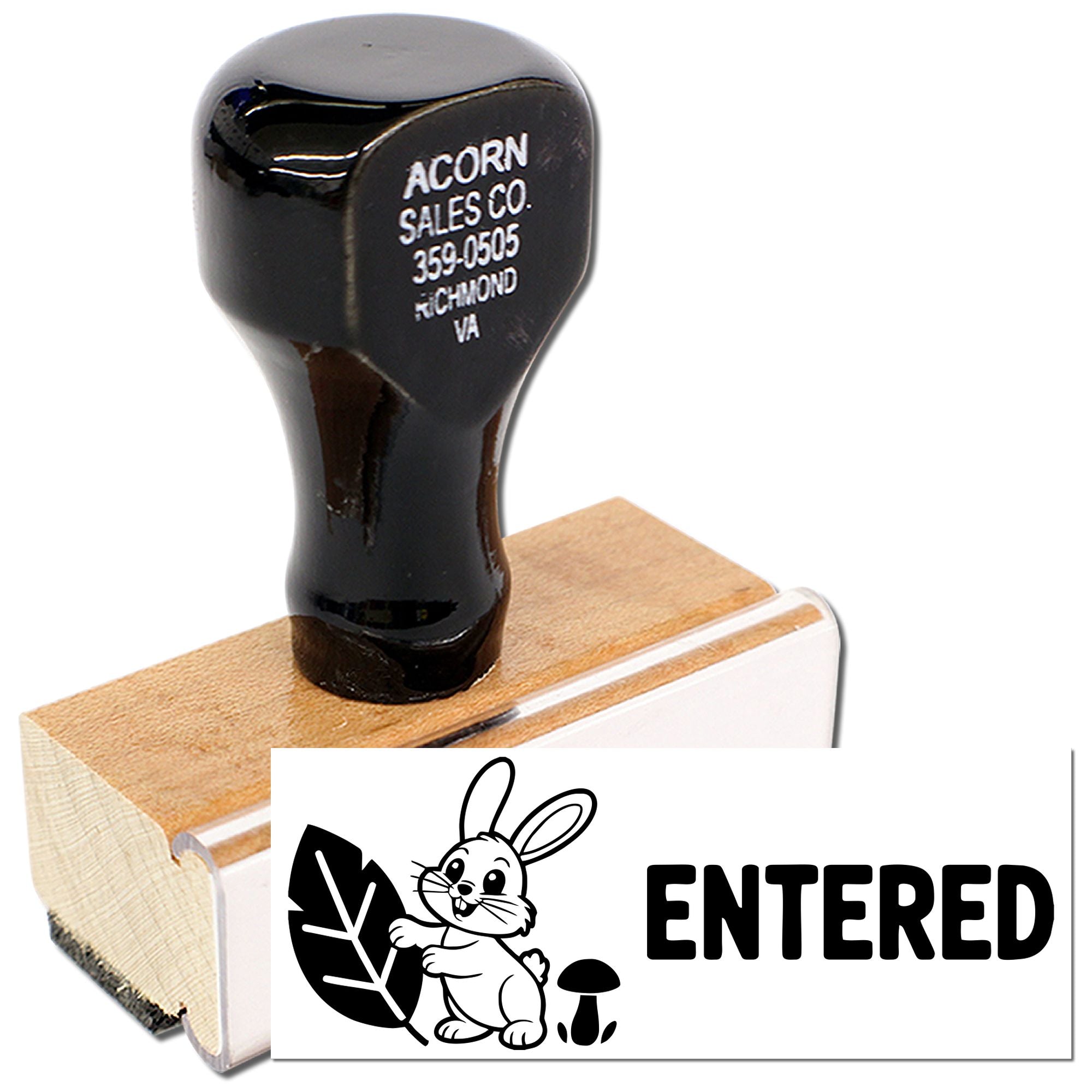 Custom hand rubber stamp with bunny logo and ENTERED imprint for office document processing.