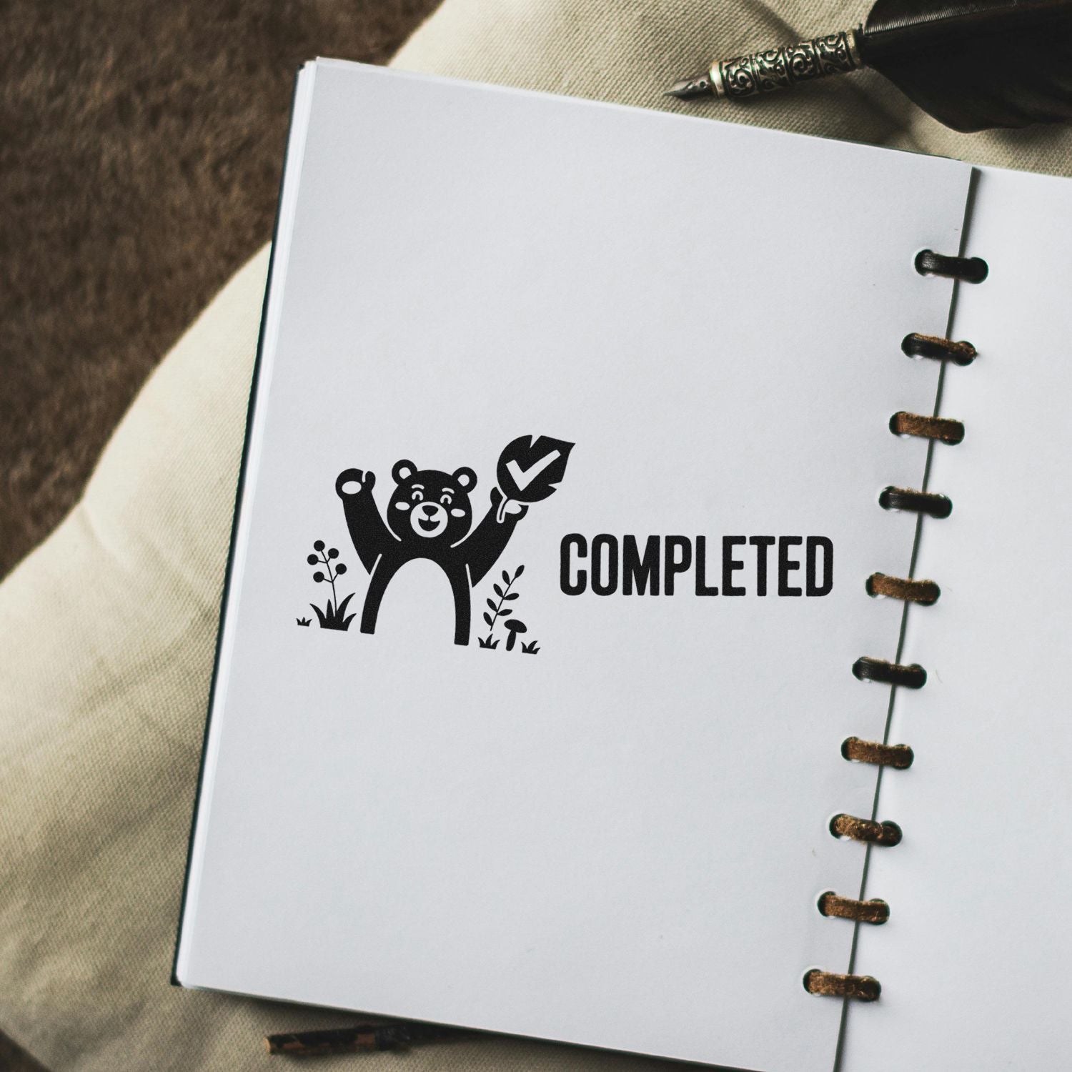 Completed rubber stamp design with bear checkmark for planners, notebooks, and task tracking
