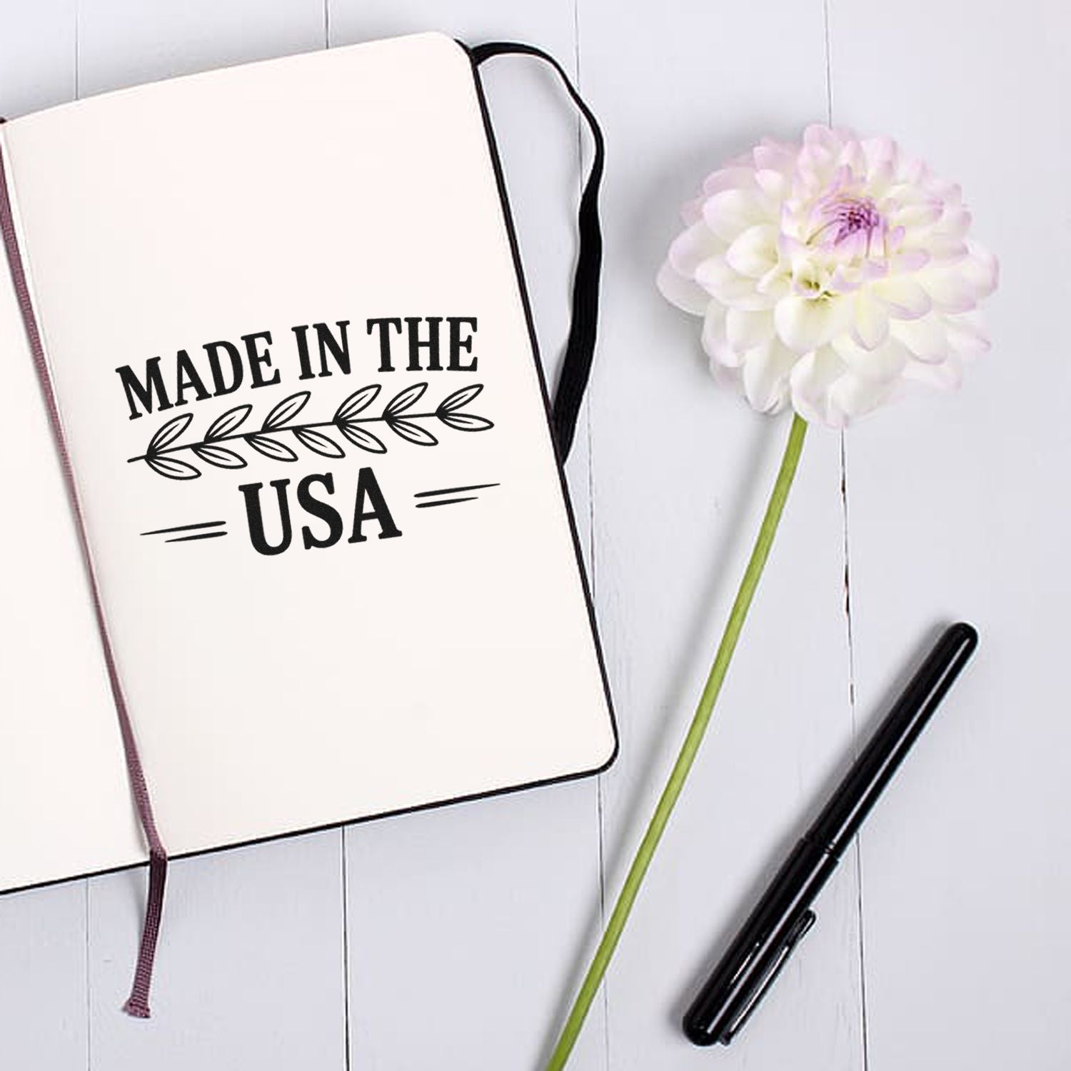 Made in the USA rubber stamp imprint on notebook, ideal for patriotic handmade product packaging and branding.