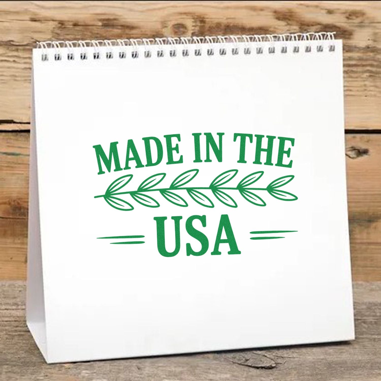 Made in the USA rubber stamp design on white gift bag with green leaf accent, ideal for patriotic packaging and crafts.