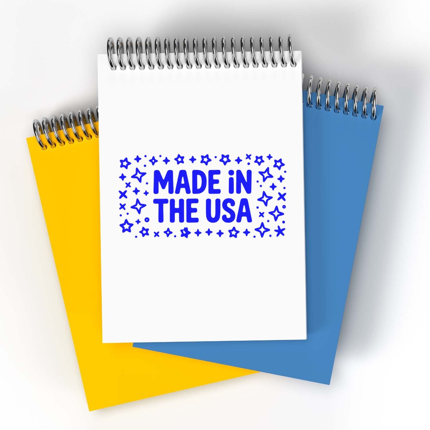 Made in the USA rubber stamp design on a spiral notebook, ideal for patriotic branding and custom stamp products.