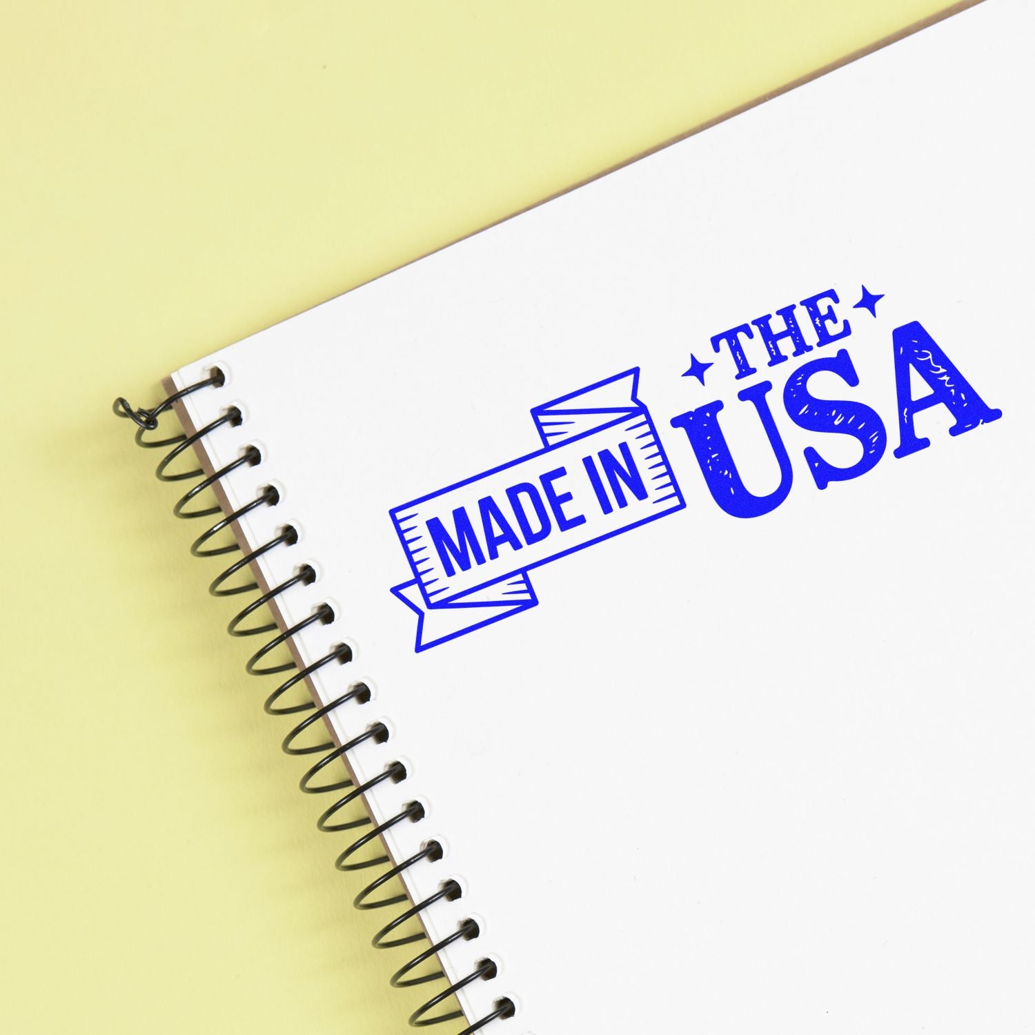 Made in USA rubber stamp on a spiral notebook, ideal for branding handmade products, packaging, and craft goods.
