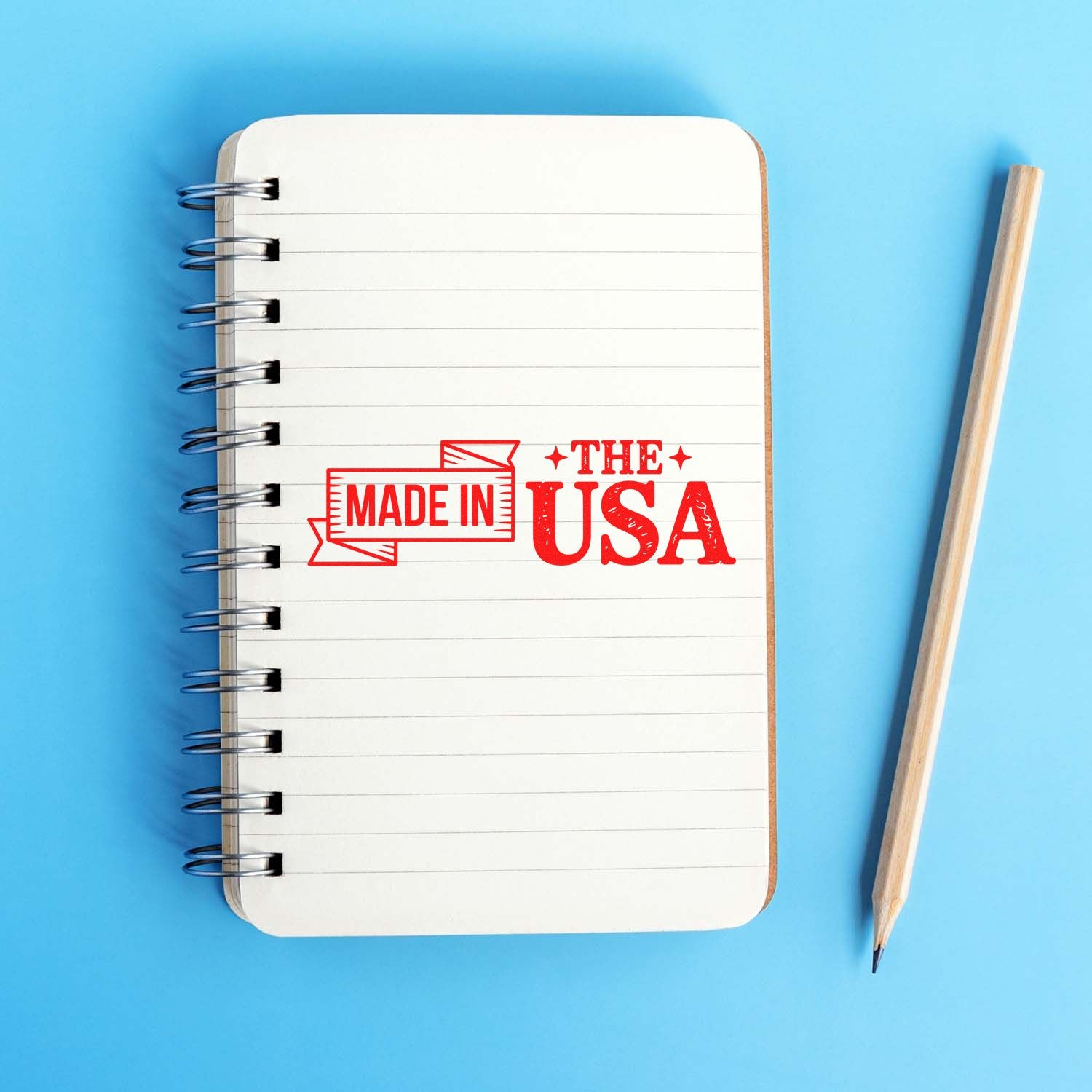 Made in the USA rubber stamp impression on a notebook page, perfect for patriotic product branding and packaging.