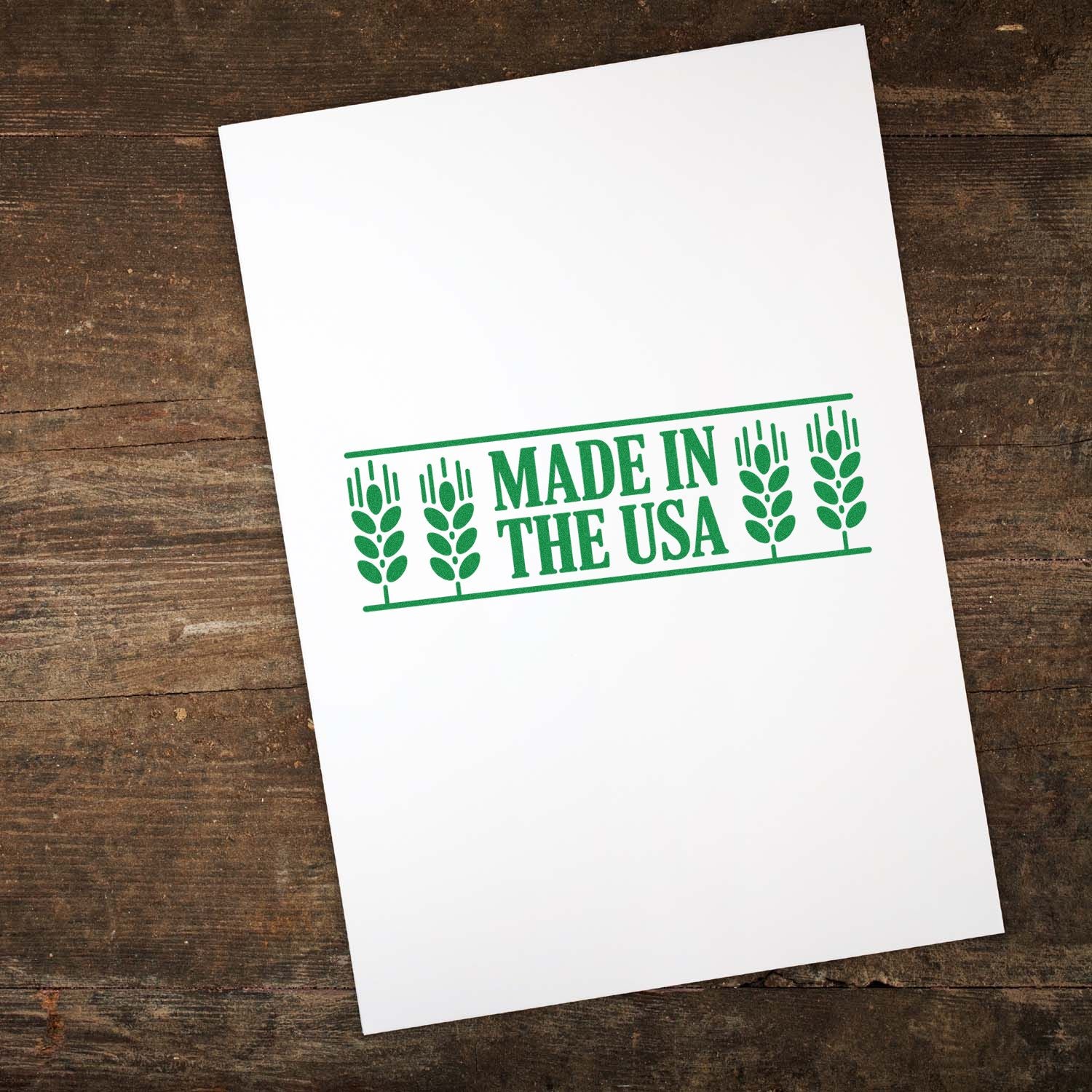 Made in the USA rubber stamp impression in green ink on paper for product packaging, branding, and handmade goods.