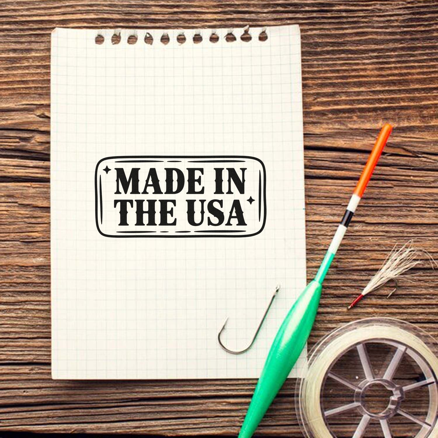 Custom Made in the USA rubber stamp impression on notebook with crafting tools for patriotic packaging and branding.