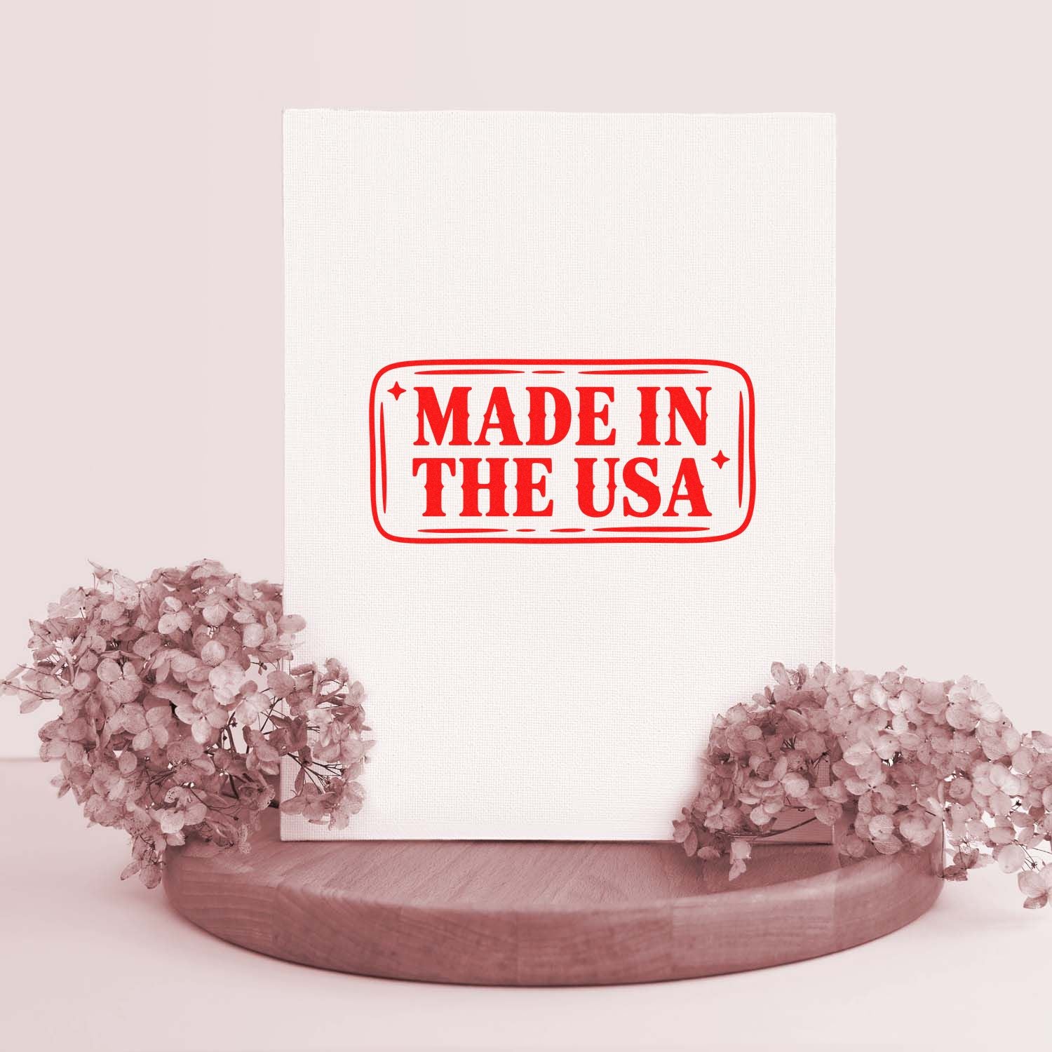 Red Made in the USA rubber stamp design displayed on a blank canvas with floral decor.