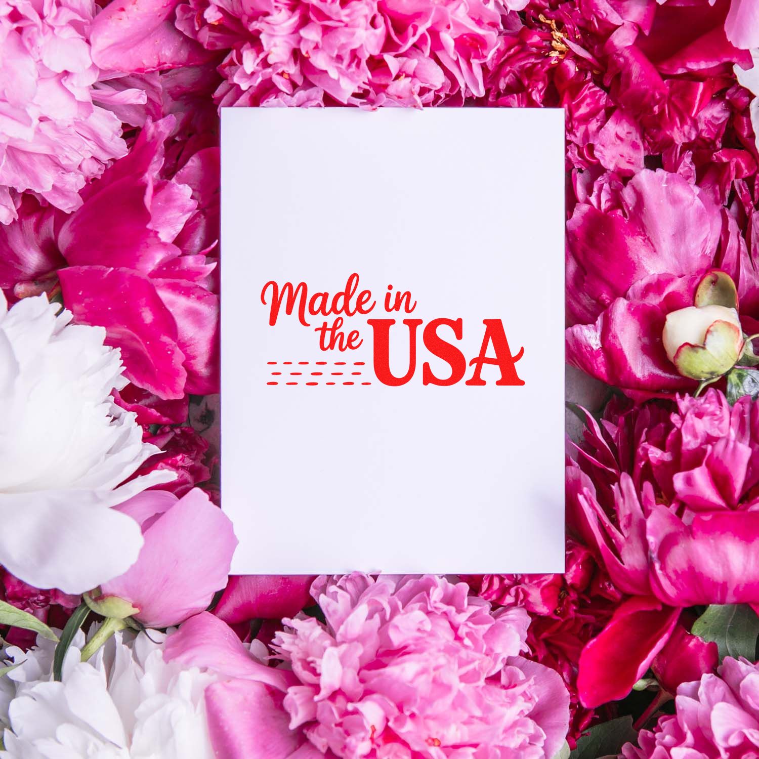 Made in the USA rubber stamp impression on white card, framed by pink flowers.