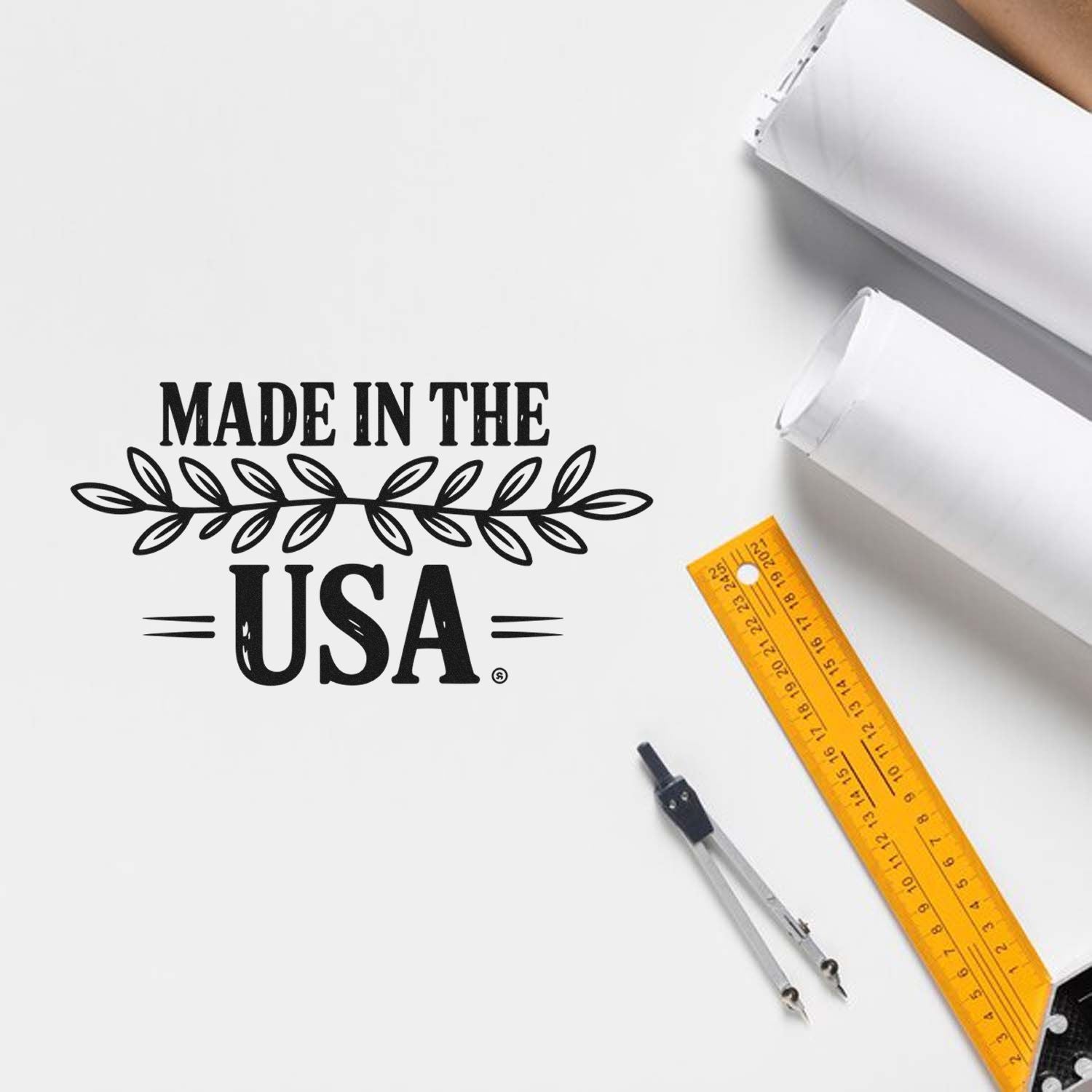 Made in the USA rubber stamp design mockup on white paper with drafting tools, ideal for custom product branding.