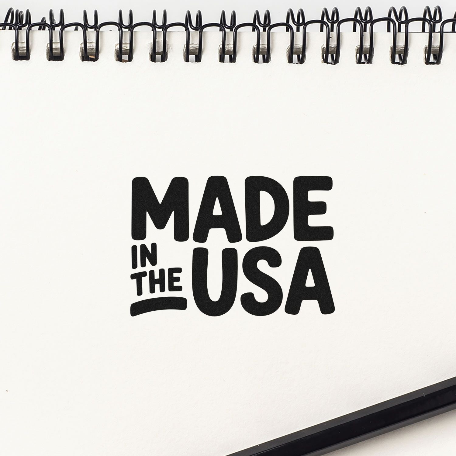 Made in the USA rubber stamp design on white sketchbook page, ideal for custom branding, packaging, and craft projects.