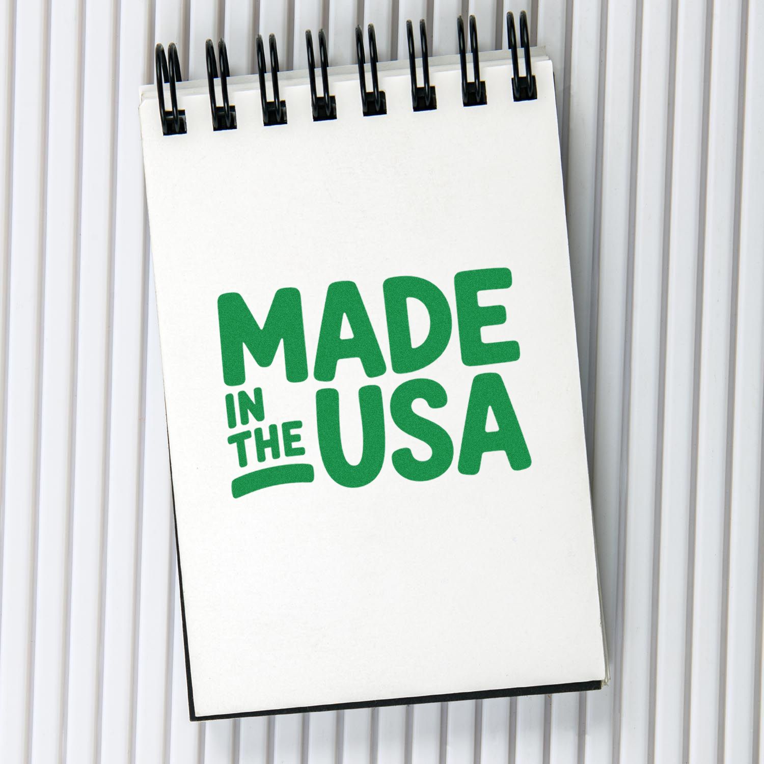 Made in the USA stamp design on notepad, ideal for custom rubber stamps and product branding.