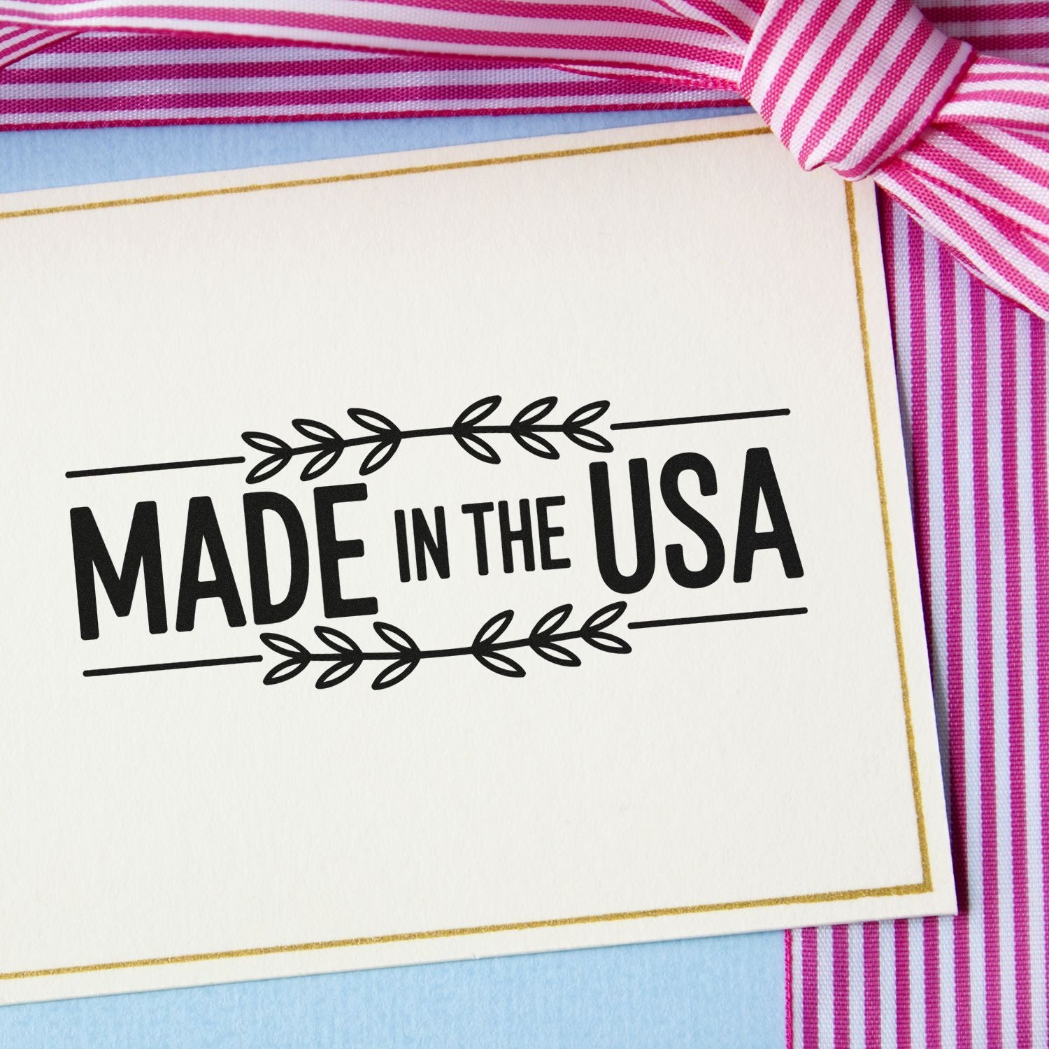 Made in the USA rubber stamp on gift card with ribbon, ideal for handmade product packaging and patriotic branding.