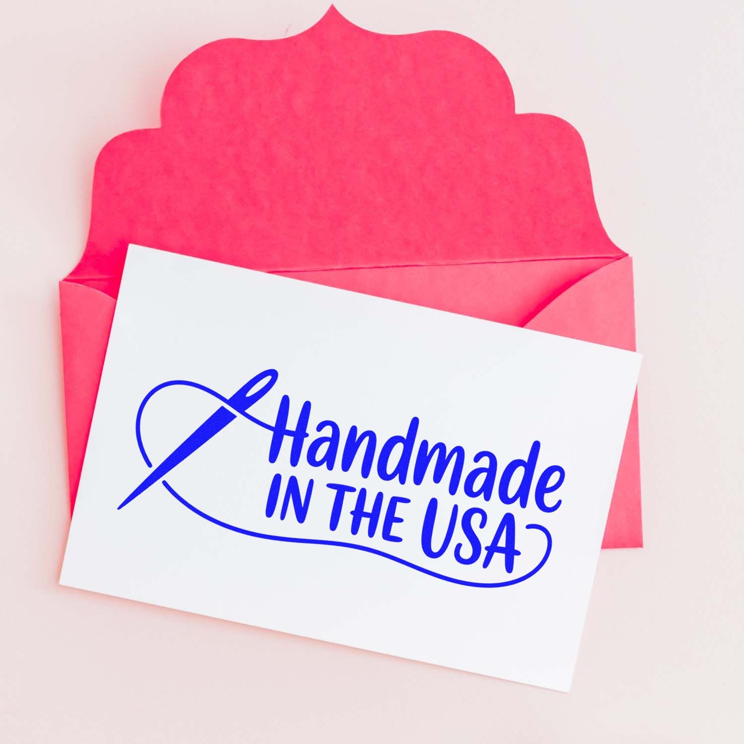 Handmade in the USA rubber stamp on a card in a pink envelope for handmade product packaging and branding.