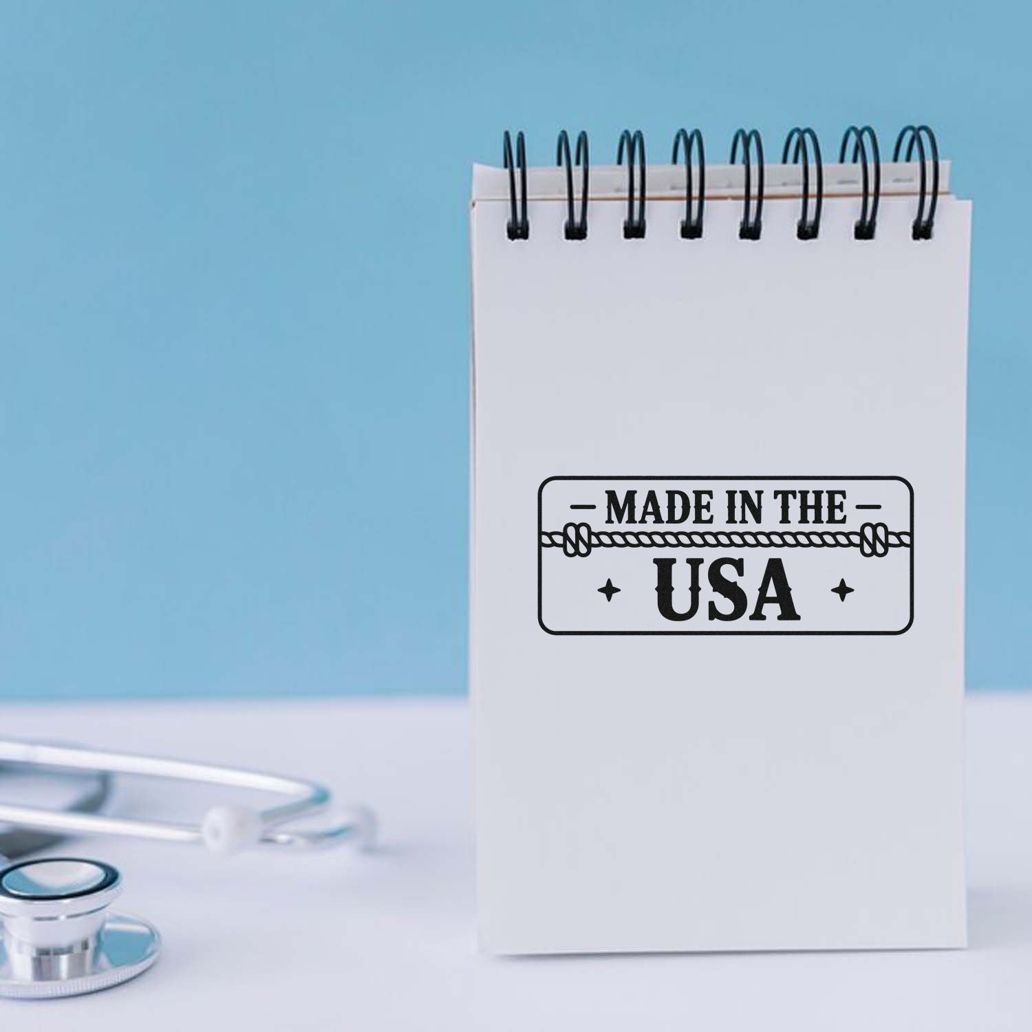 Made in the USA rubber stamp impression on a spiral notebook, ideal for product branding, packaging, and handmade business labels.