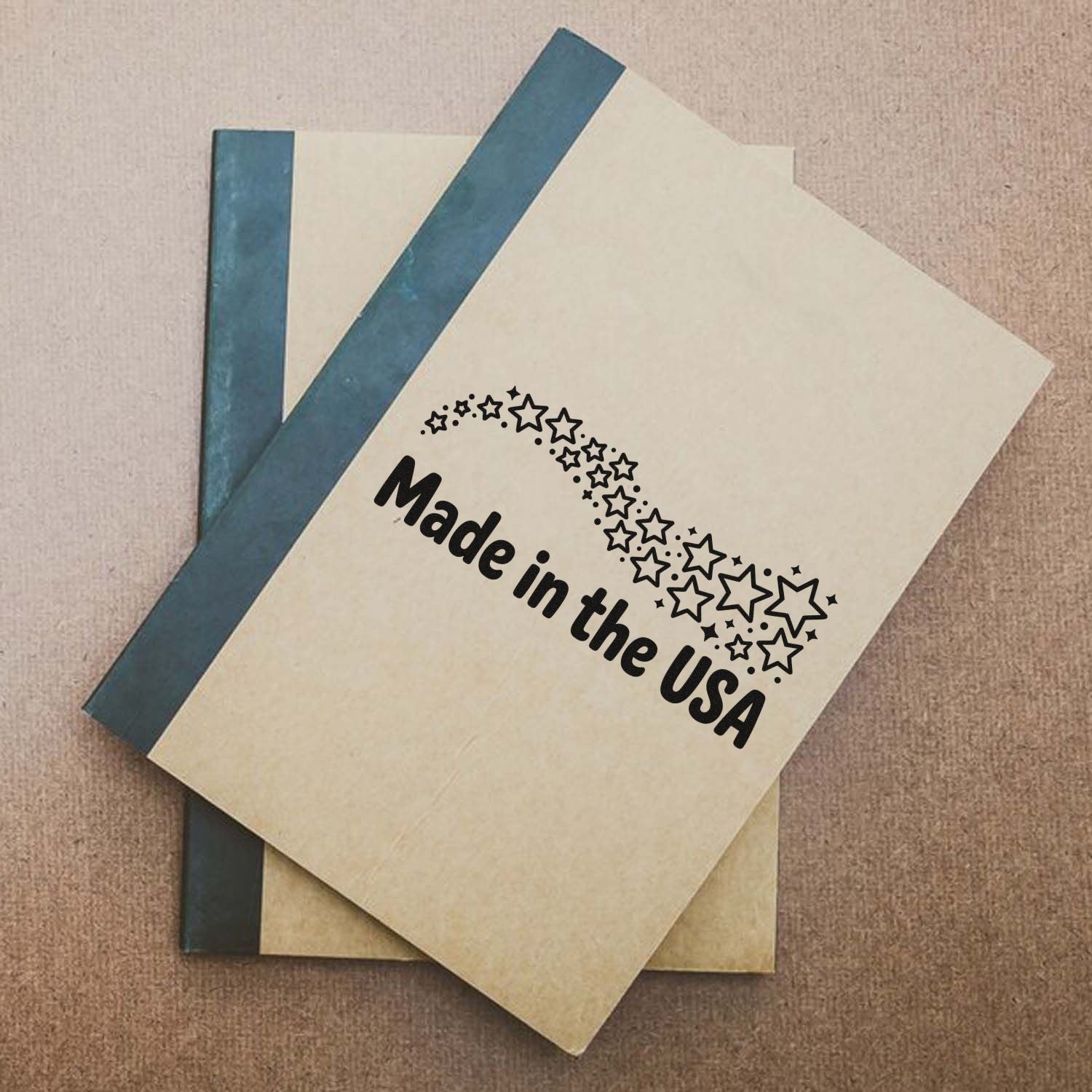 Made in the USA rubber stamp design with stars on a notebook cover, ideal for product packaging and branding.