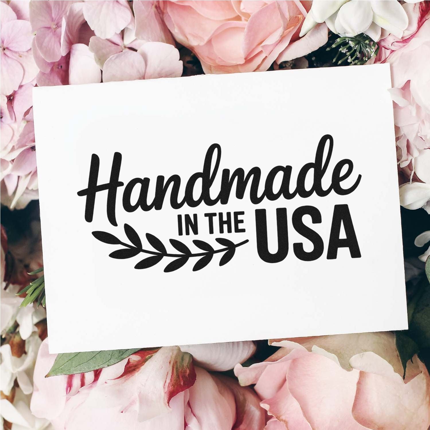 Handmade in the USA rubber stamp design on floral background, ideal for artisan packaging, branding, and craft products.