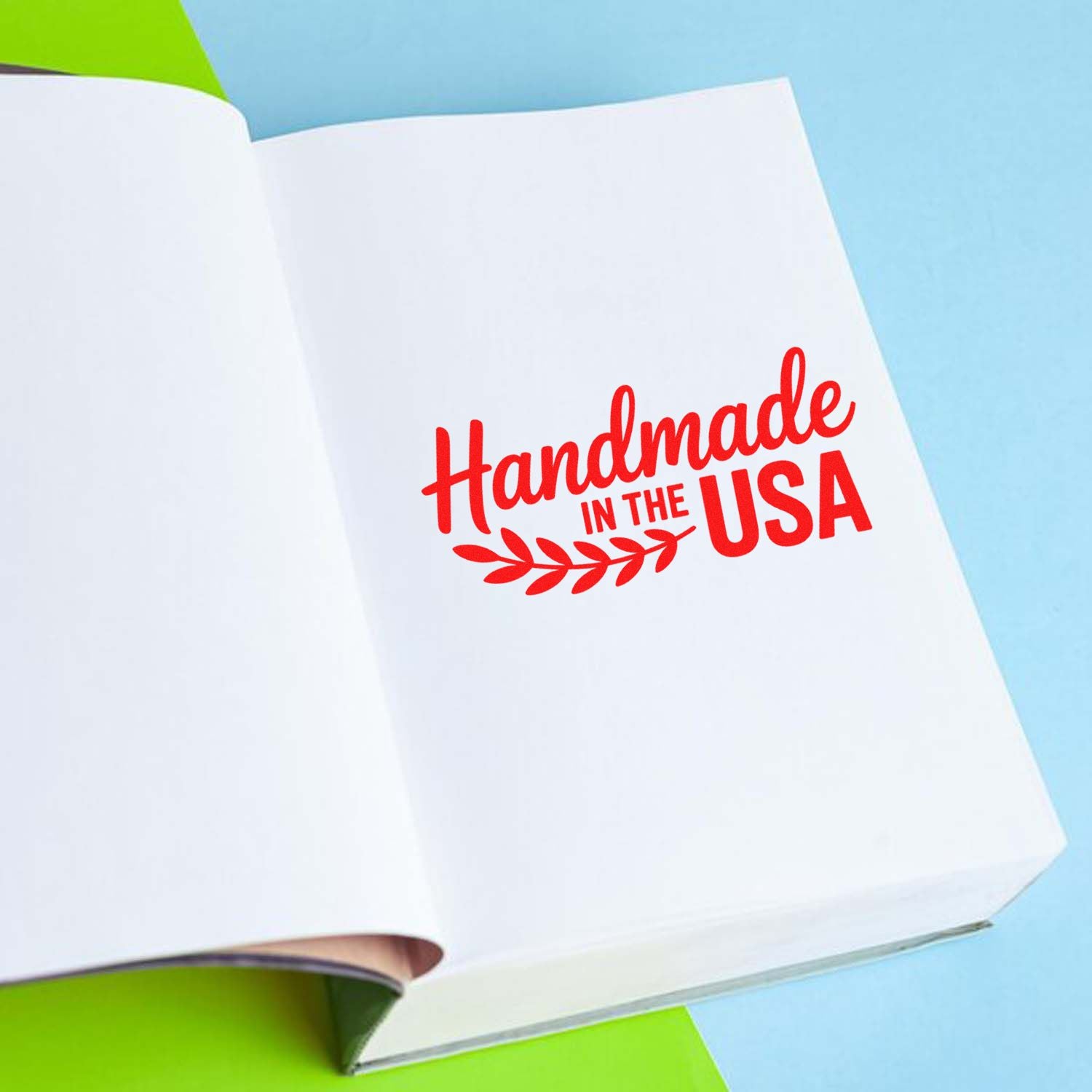 Handmade in the USA rubber stamp on a notebook page for custom craft branding, product packaging, and small business labels.