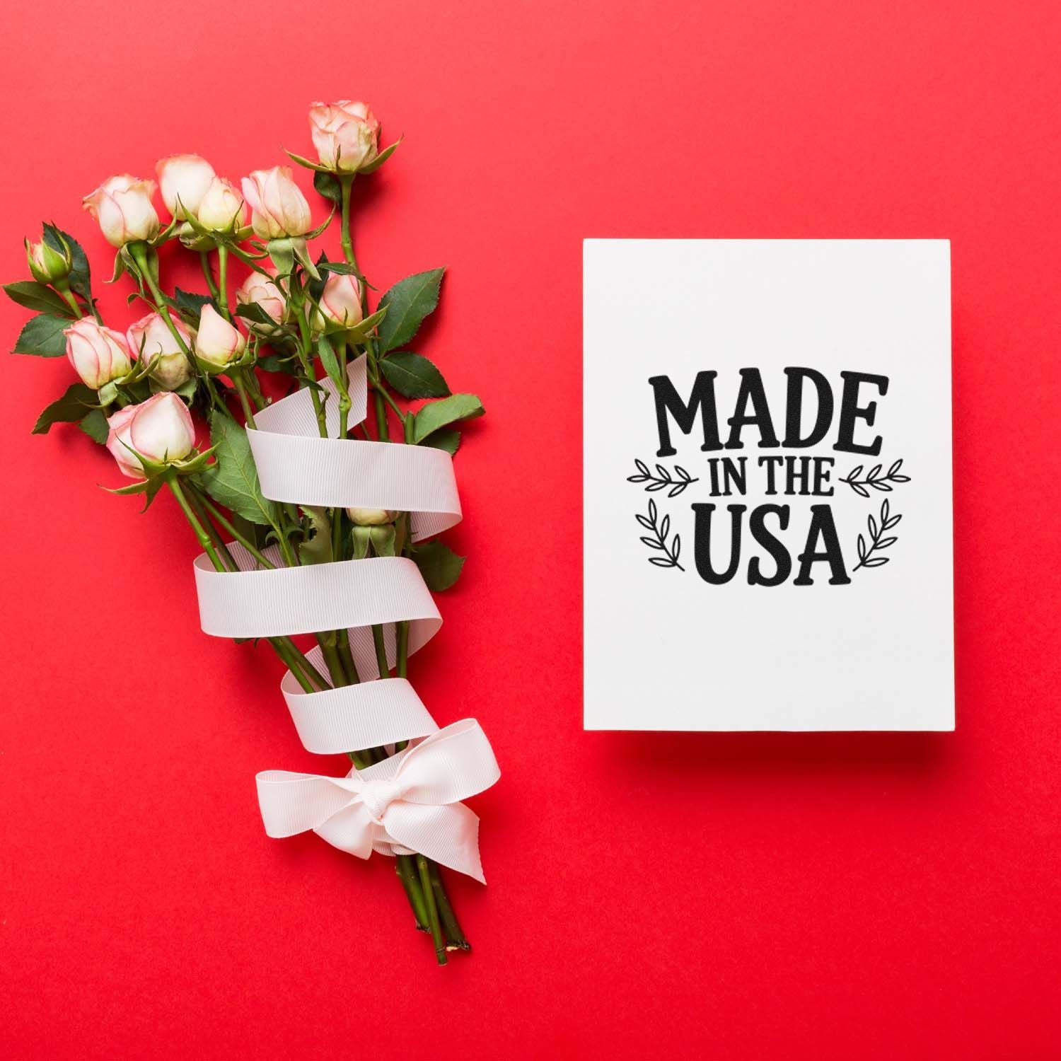 Made in the USA rubber stamp on card beside rose bouquet with ribbon, ideal for handmade gifts and patriotic product packaging.