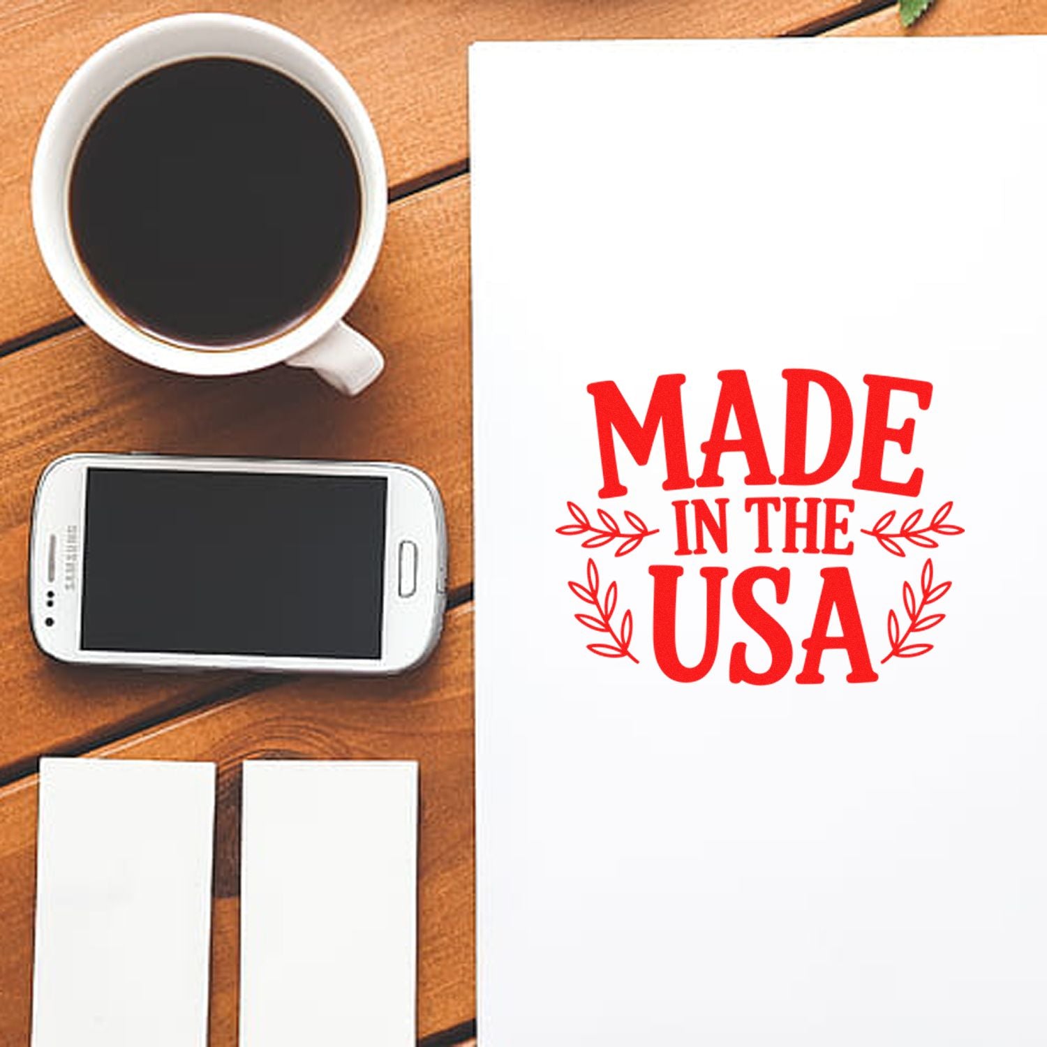 Made in the USA rubber stamp mockup on white paper, styled with coffee and phone for branding, packaging, and stationery.