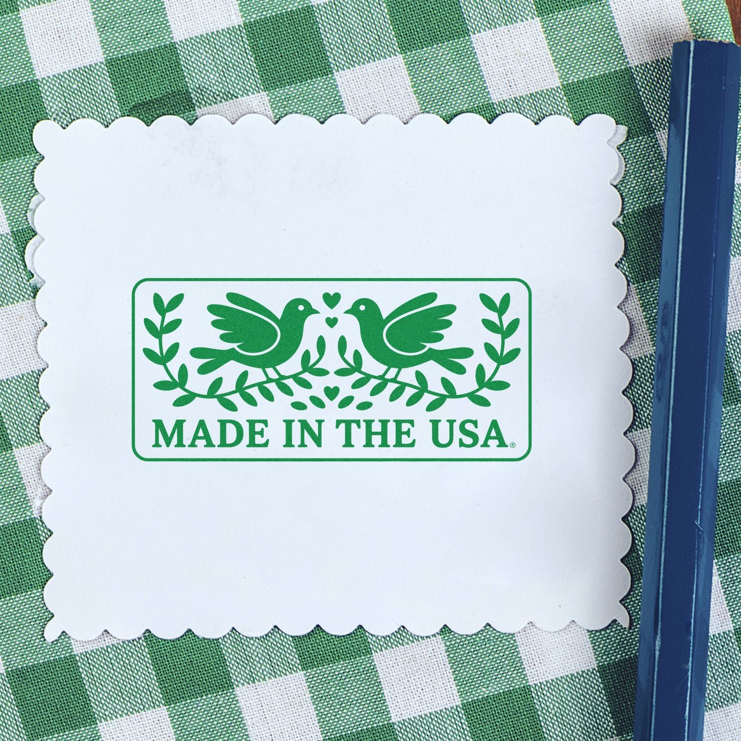 Made in the USA rubber stamp with green bird and leaf logo, shown as a custom stamp imprint on a scalloped card.