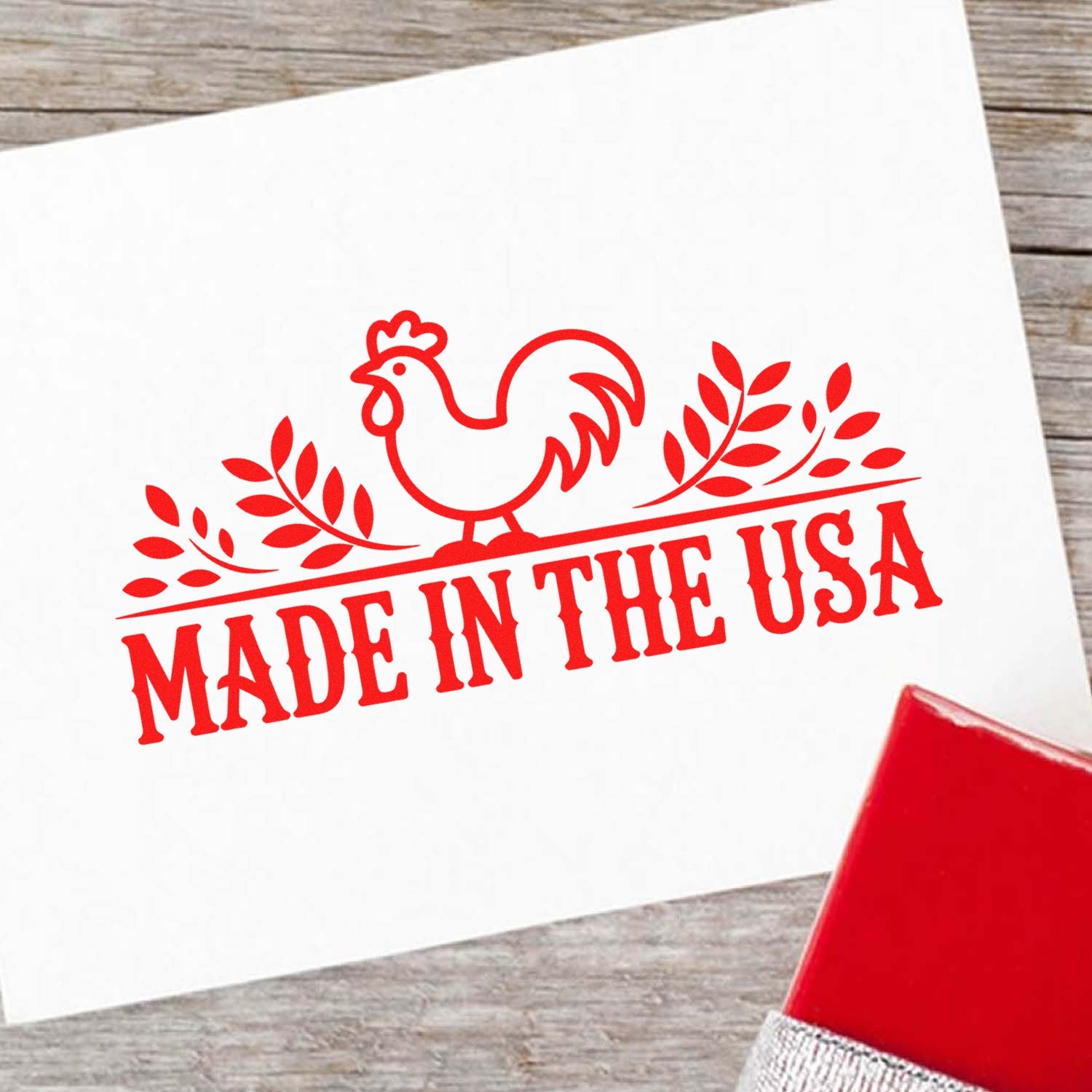 Made in the USA rubber stamp imprint with rooster design and leaves, shown in red ink on white paper.