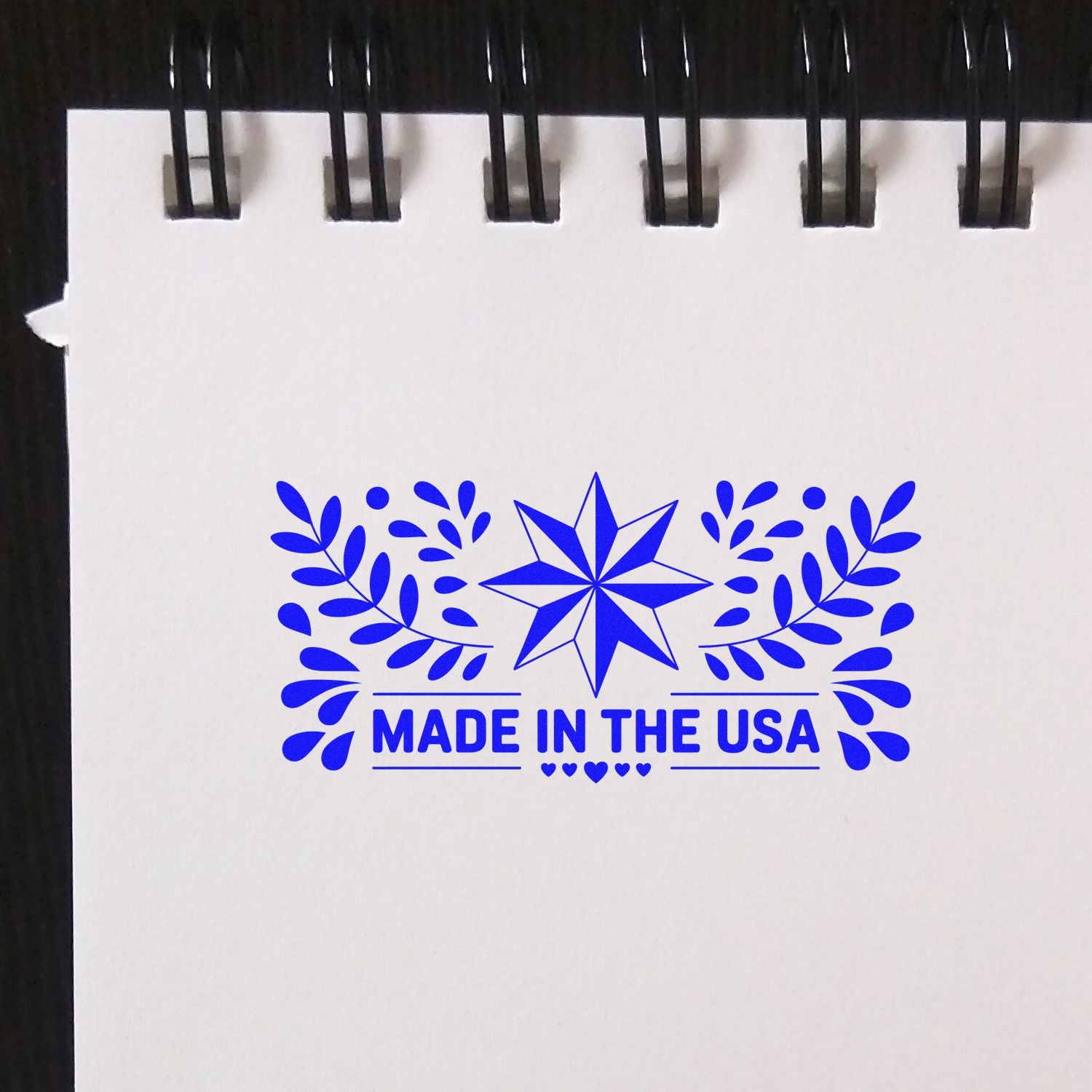 Made in the USA rubber stamp design with blue star and leaf accents for patriotic product branding