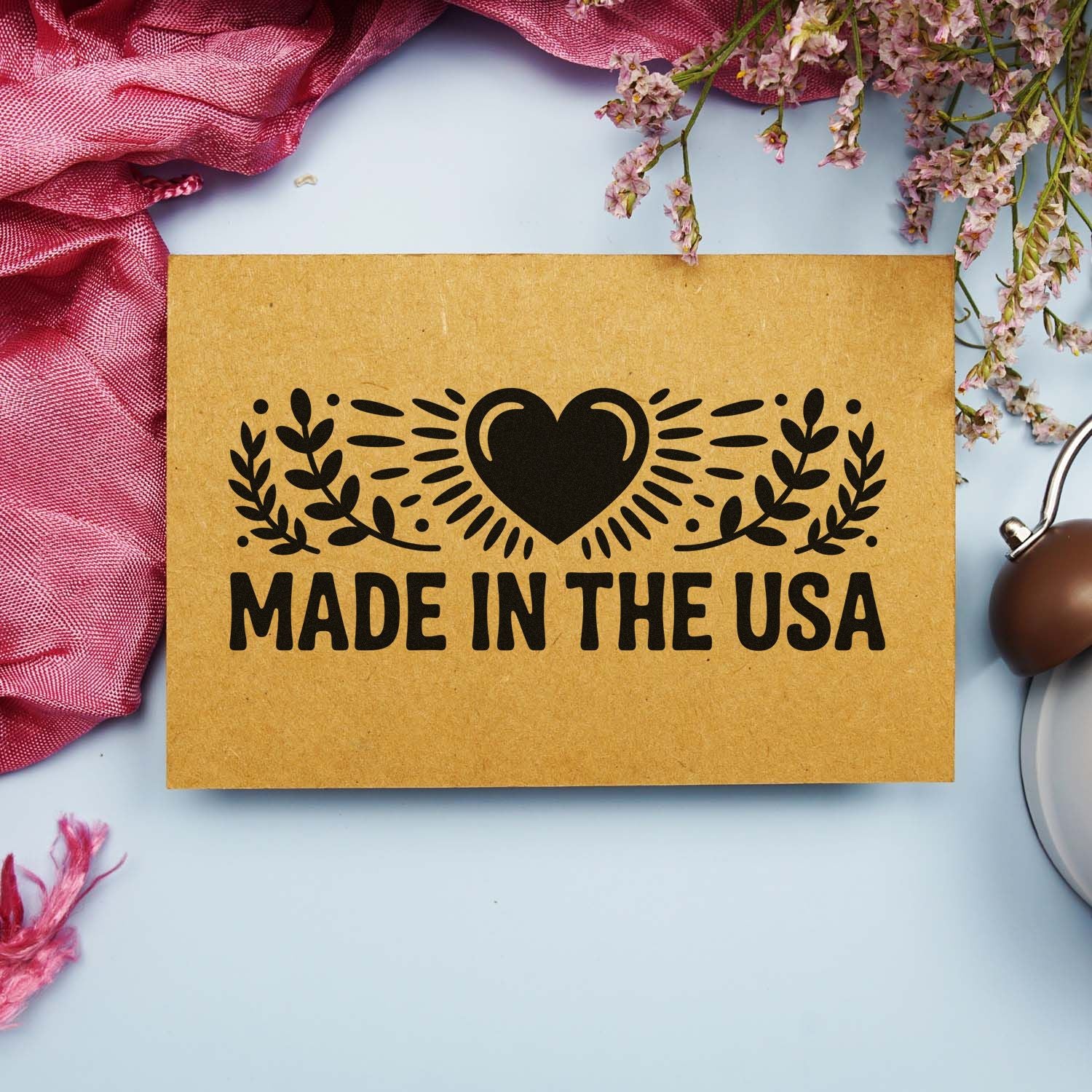 Made in USA rubber stamp design with heart and laurel motif on kraft paper, ideal for handmade product packaging.