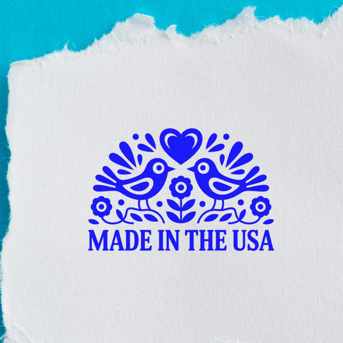 Made in USA rubber stamp impression featuring blue birds, flowers and heart on textured paper.