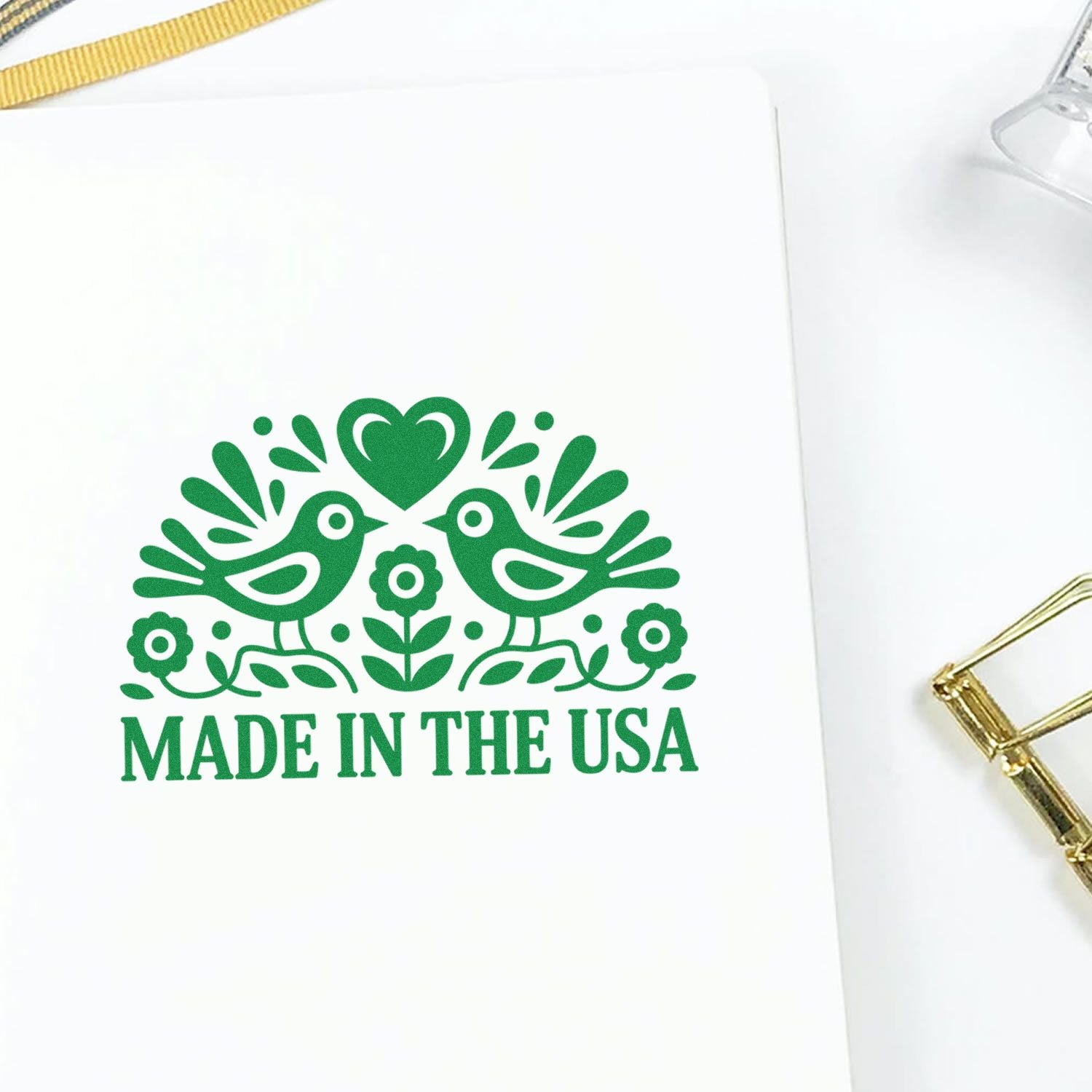 Made in the USA rubber stamp imprint with birds, heart and floral design for packaging or branding.