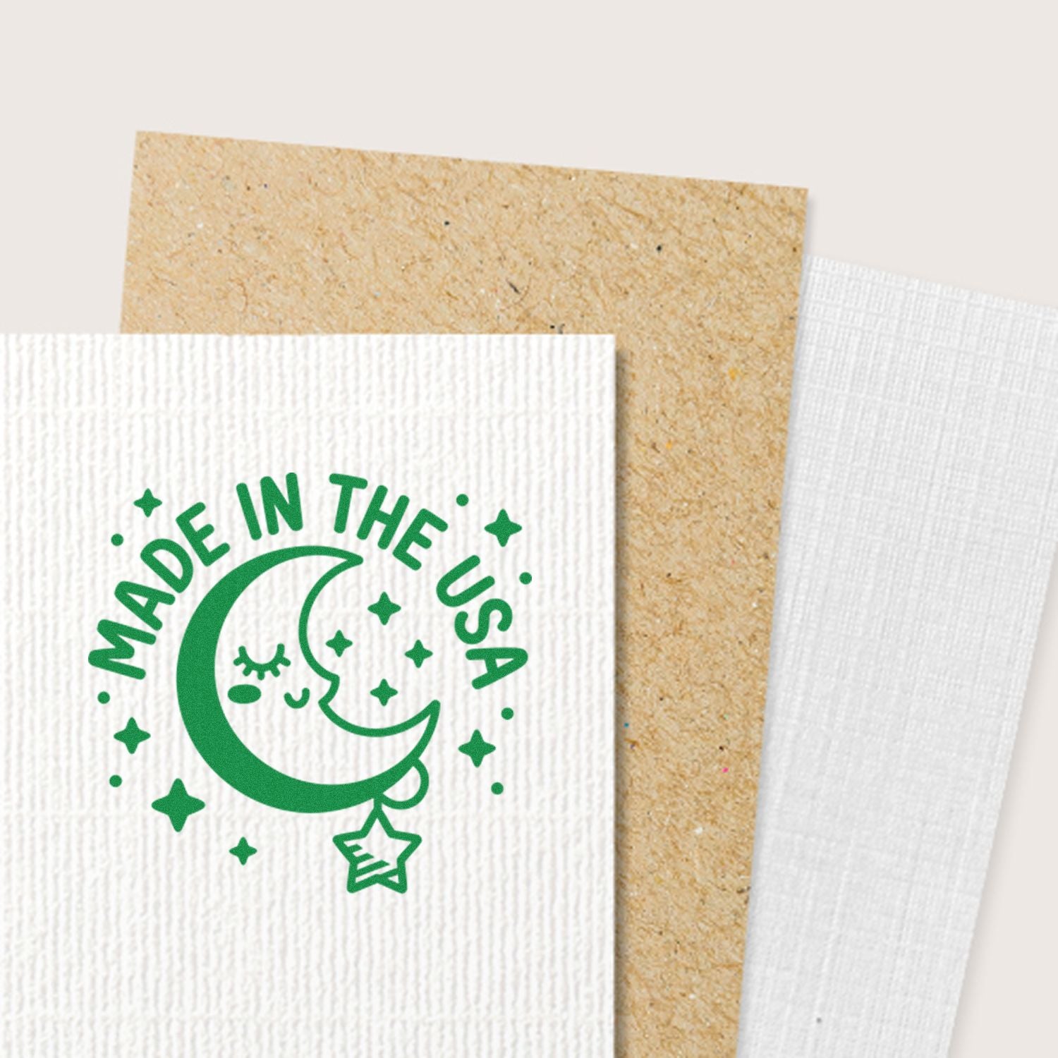 Green Made in the USA moon and stars rubber stamp on textured cardstock for custom packaging and patriotic branding.