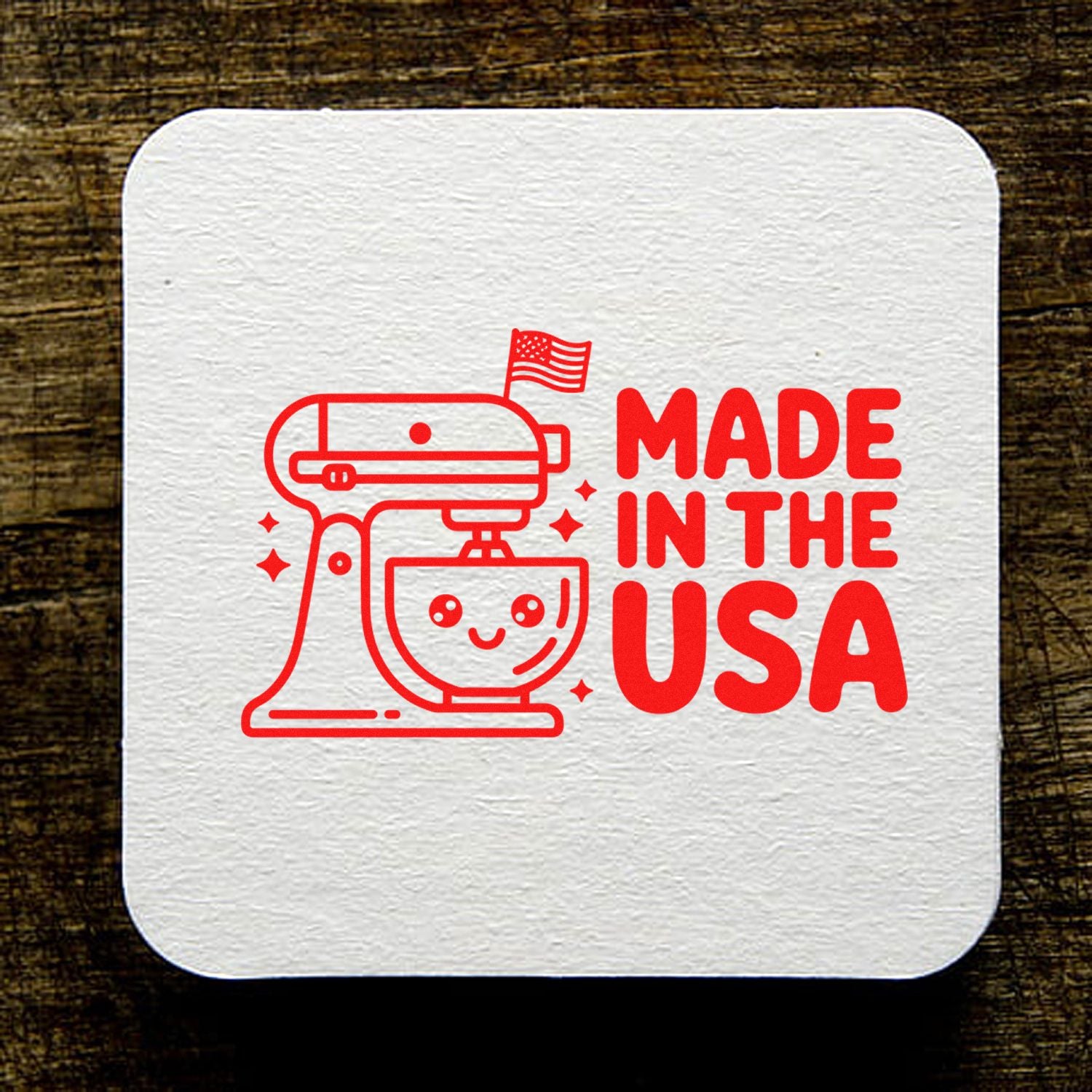 Made in USA rubber stamp design featuring a stand mixer and American flag on textured white paper.