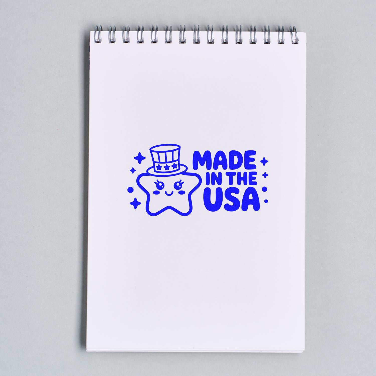 Made in the USA rubber stamp design with cute star mascot on notebook mockup for patriotic branding