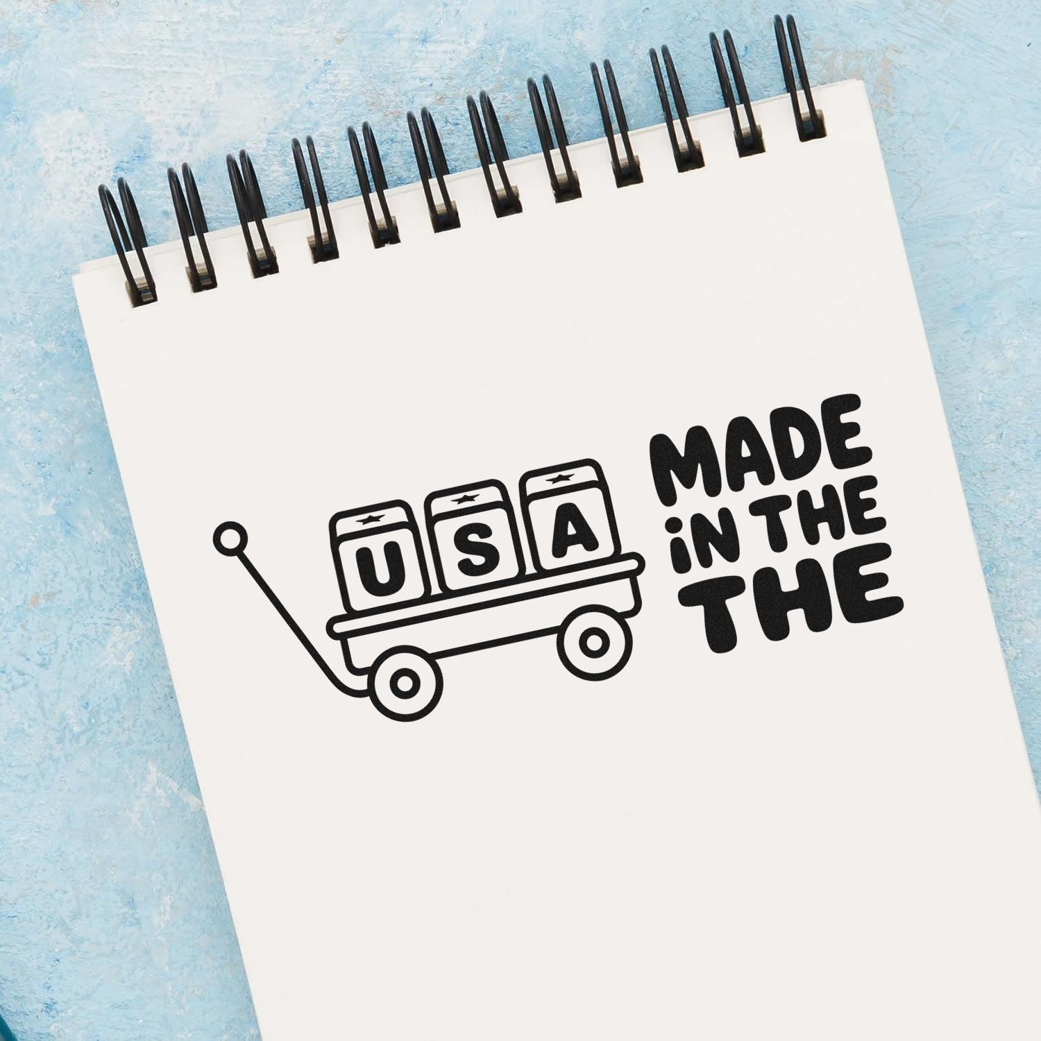 Made in the USA rubber stamp design with patriotic wagon and USA letters for craft, packaging, and handmade branding.