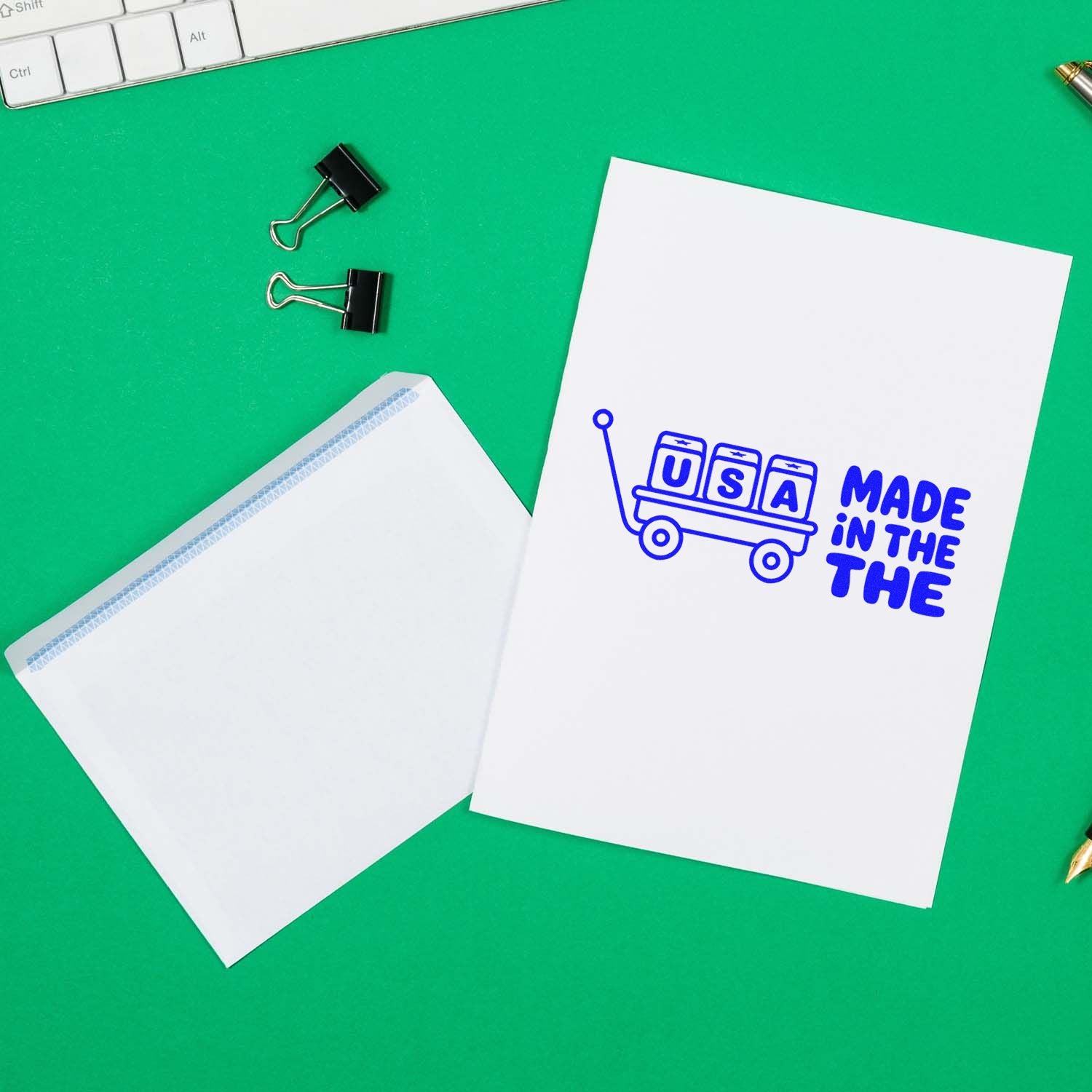 Made in the USA rubber stamp design on paper and envelope, with office supplies on a green desk background.