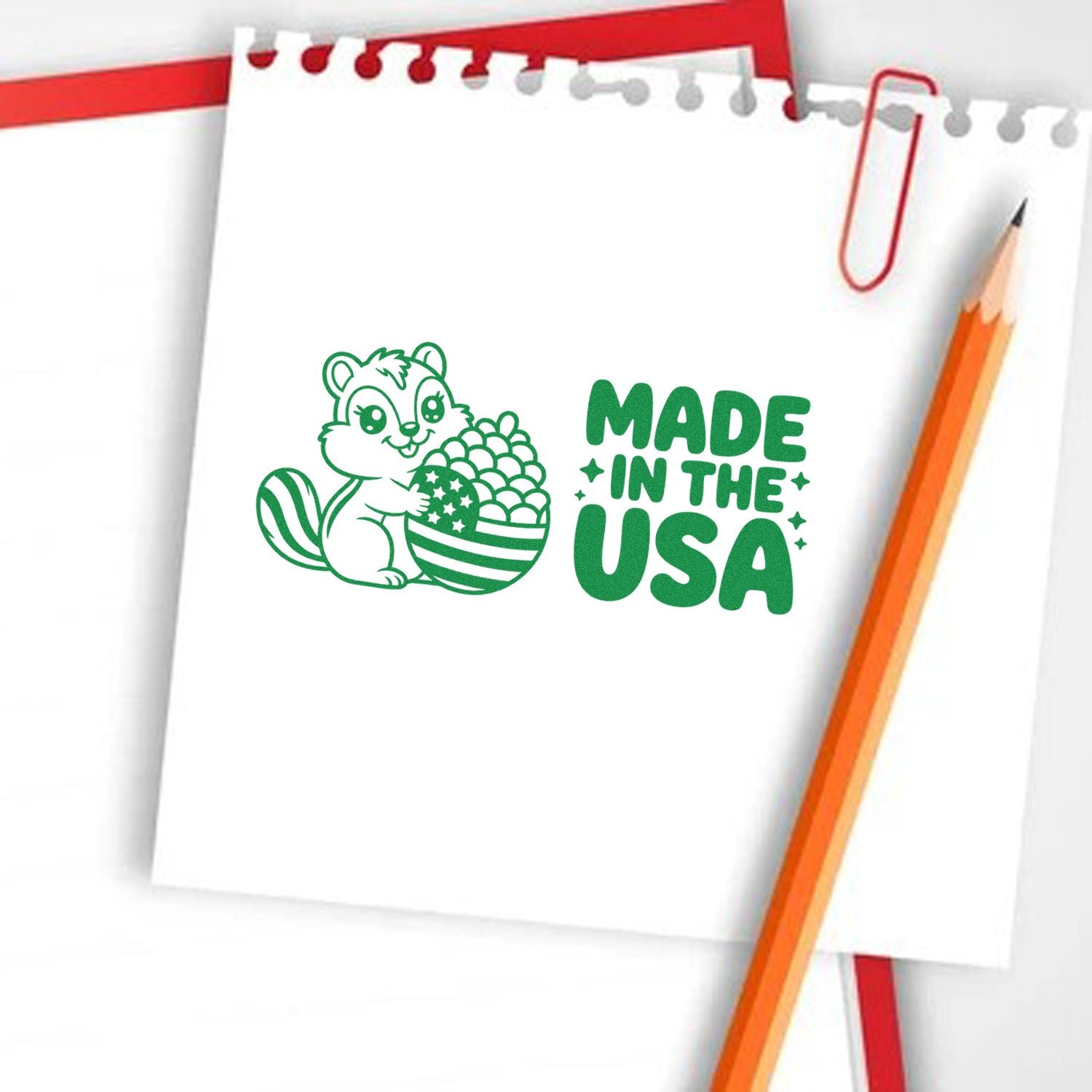 Made in USA rubber stamp design with cartoon squirrel and patriotic acorn on notebook paper mockup.
