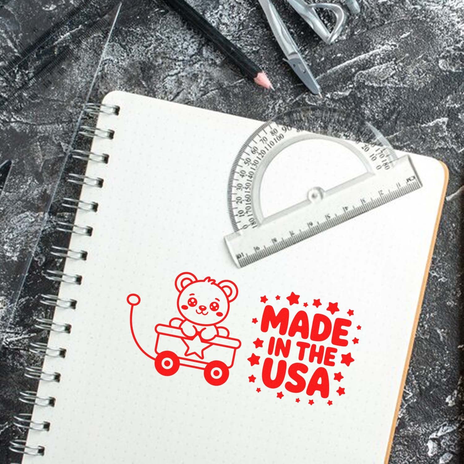 Custom Made in the USA rubber stamp design with teddy bear wagon, ideal for handmade branding on notebooks.