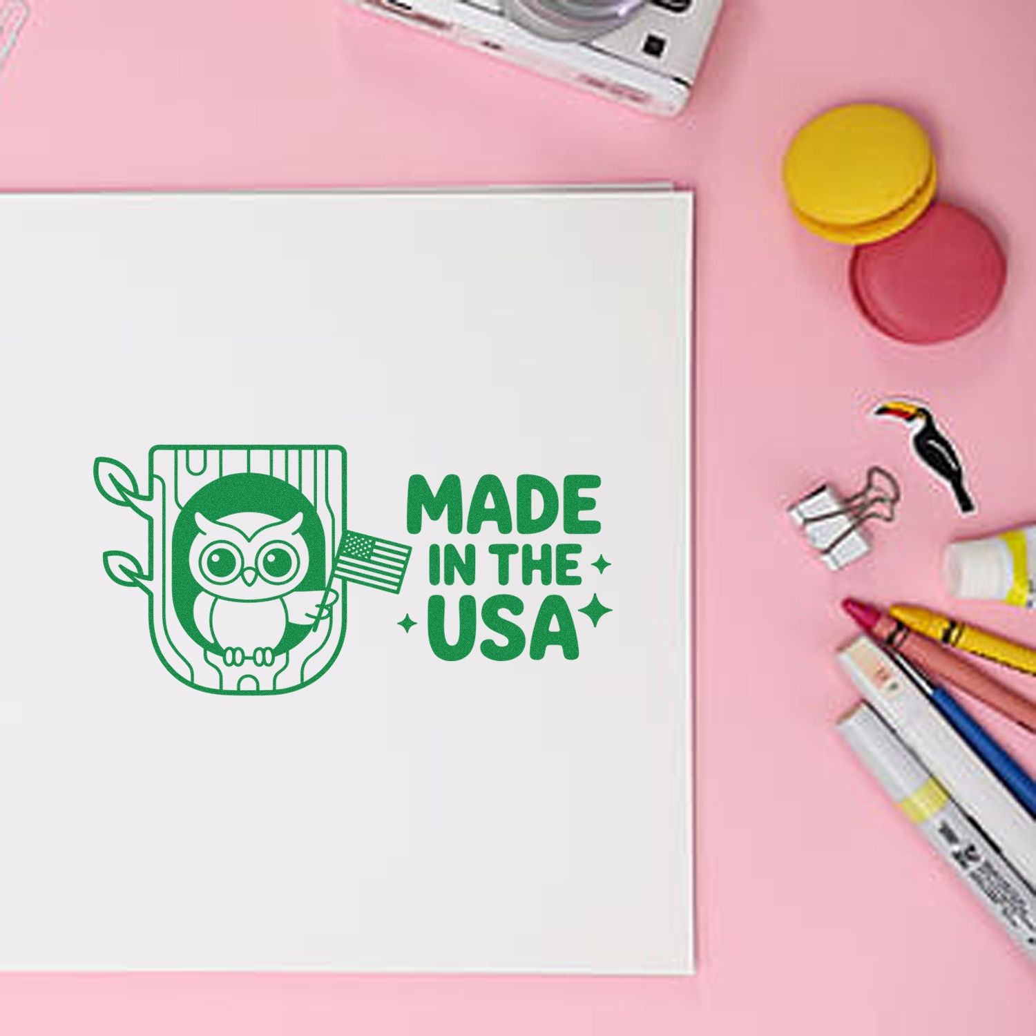 Custom owl rubber stamp with Made in the USA design on paper, surrounded by craft supplies for stamping projects.
