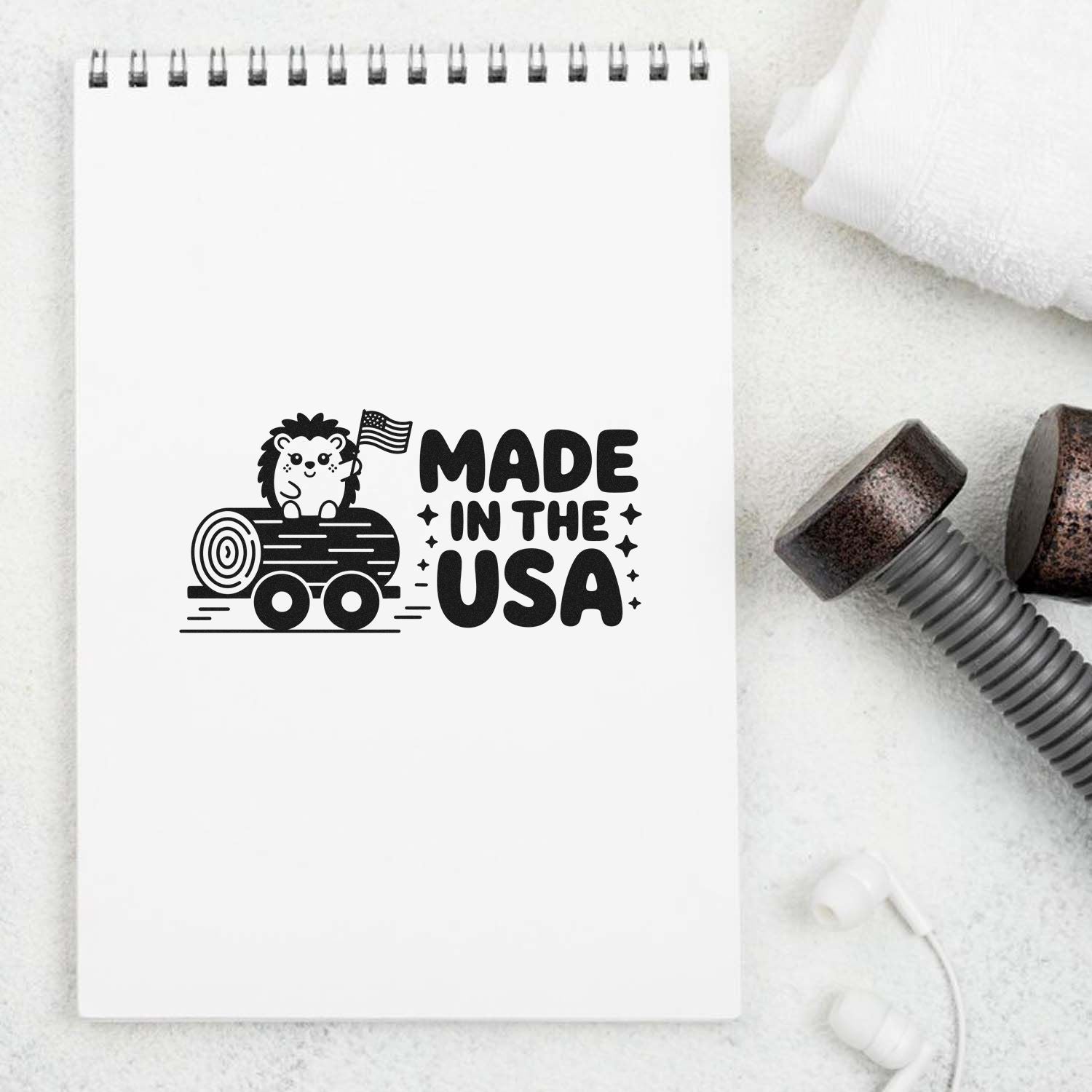 Made in the USA rubber stamp design featuring a hedgehog and log, displayed on a notebook with stamp handles.