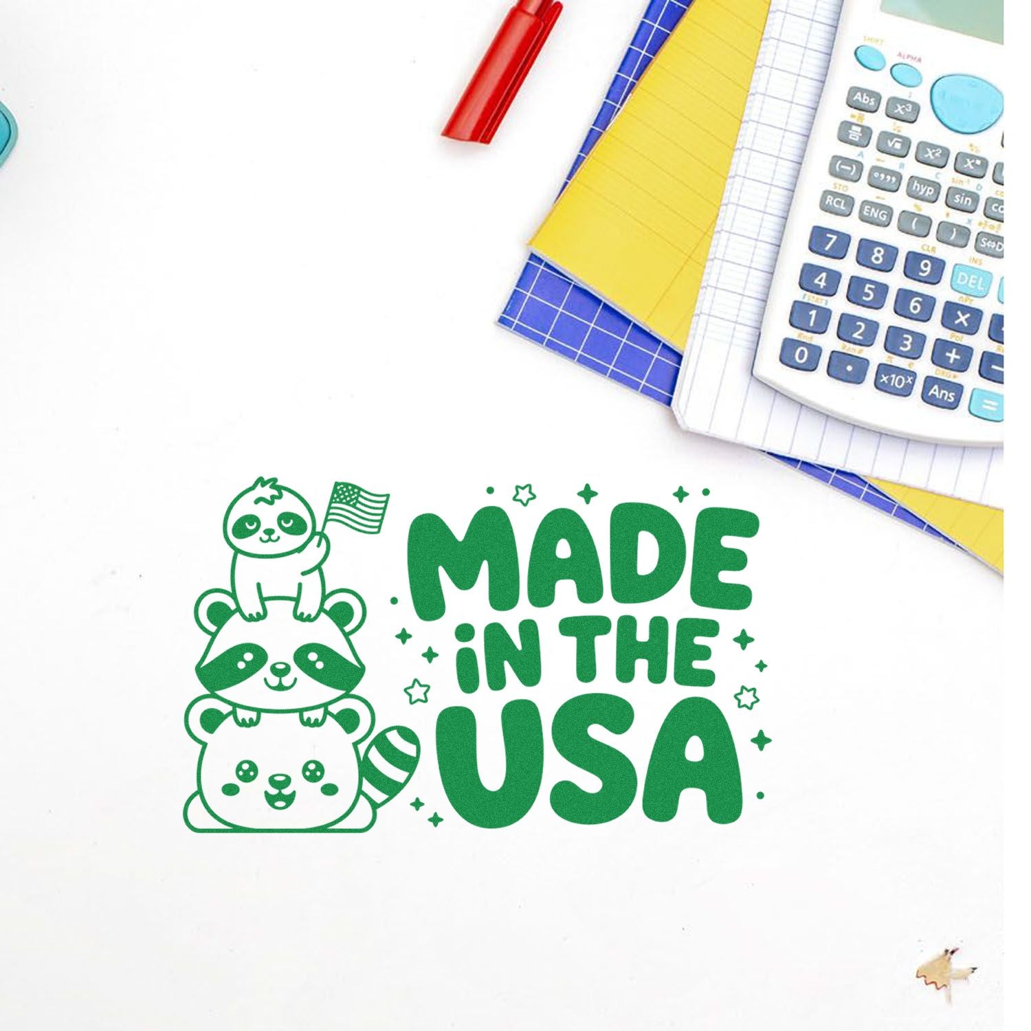 Made in the USA rubber stamp design with cute stacked raccoons and American flag, shown on a notebook with school supplies.