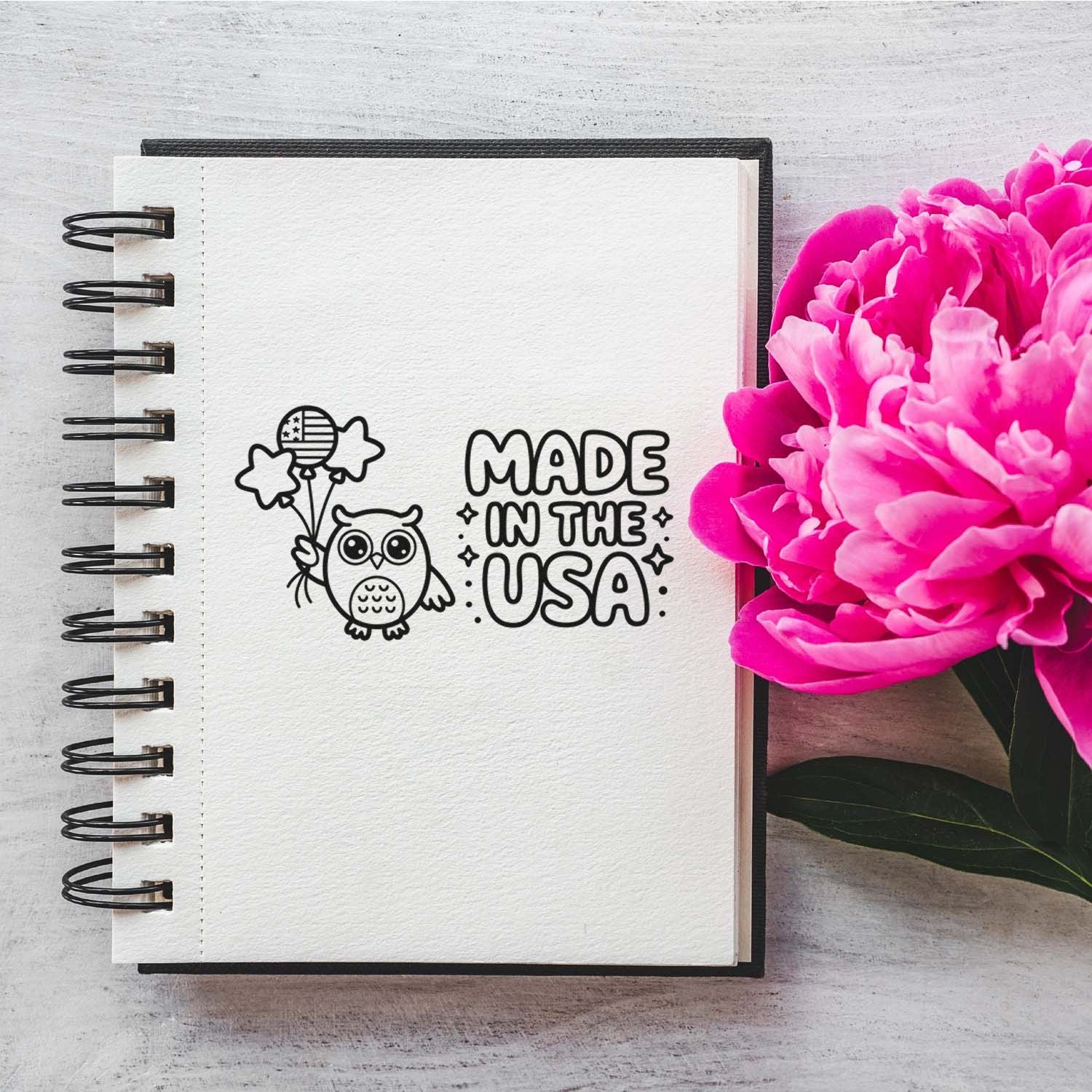 Patriotic Made in the USA rubber stamp with owl and balloons, shown on a notebook page for handmade craft branding.