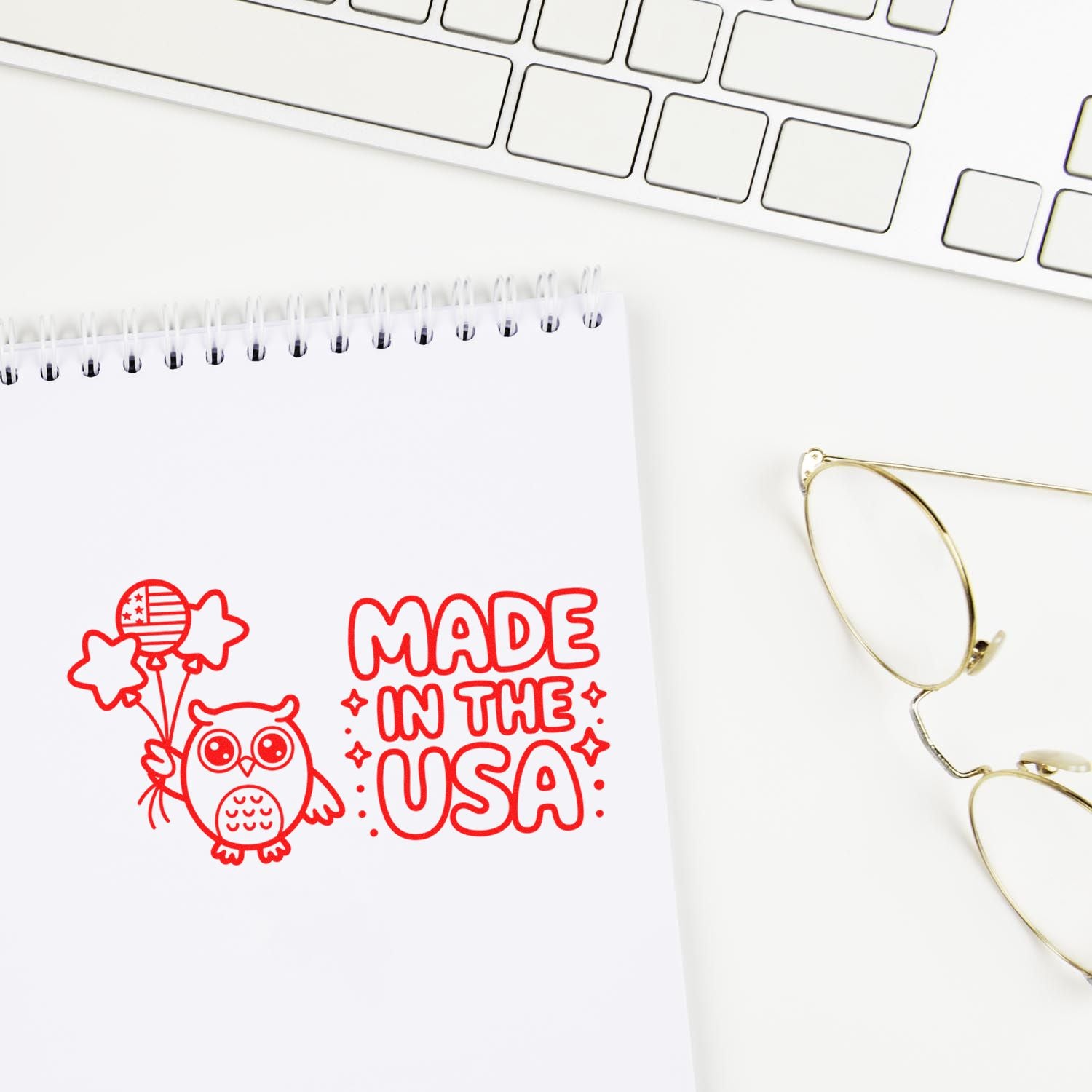 Made in the USA rubber stamp impression with owl and balloons on notebook, ideal for branding, crafts, and packaging.